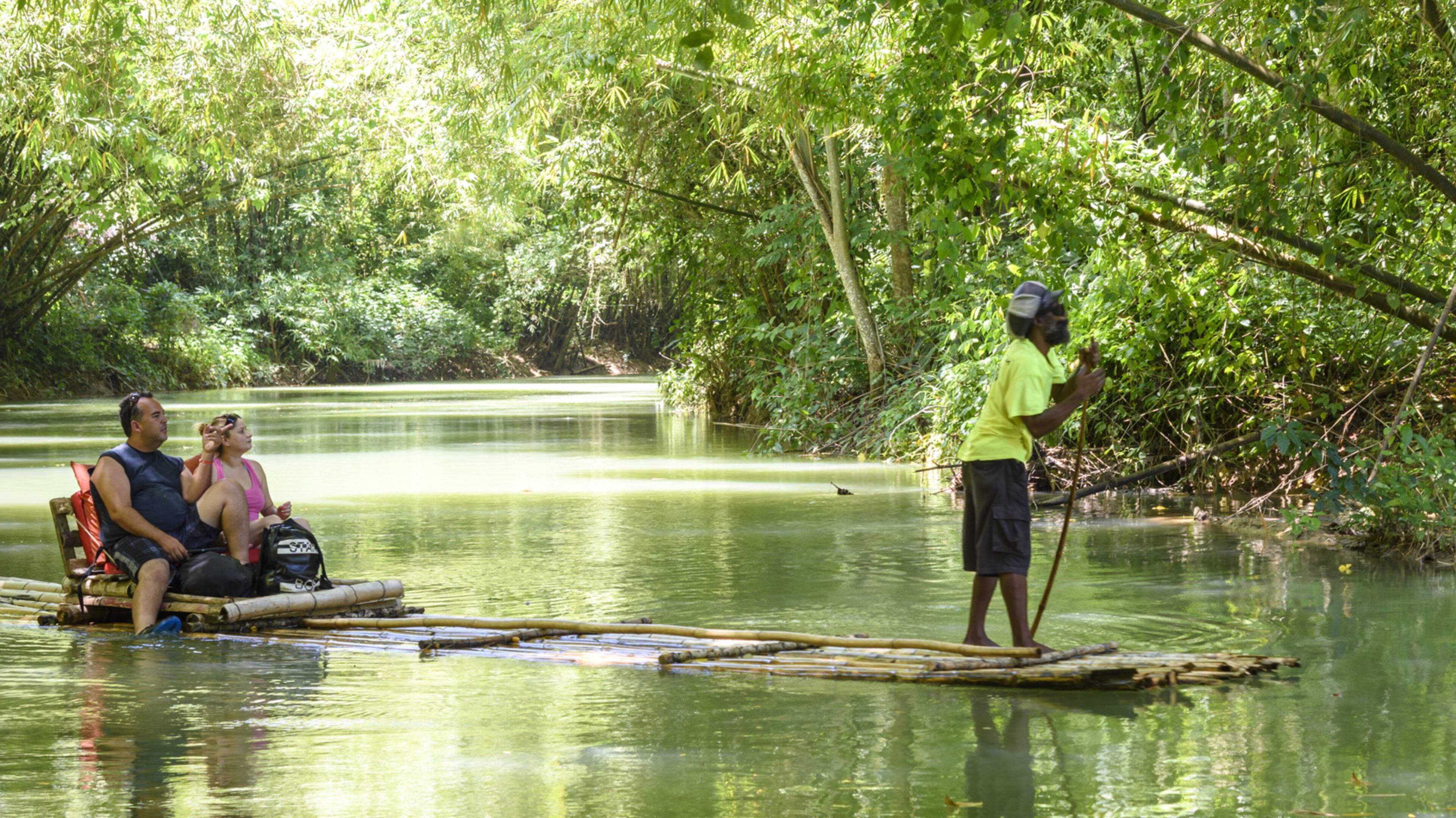 A couple on a rafting ride on the Martha Brae River in Falmouth, Jamaica, July 13, 2016. Usain Bolt, the Olympic gold medalist sprinter, recommends a run along this river, near his hometown of Sherwood Content. (Moris Moreno/The New York Times)