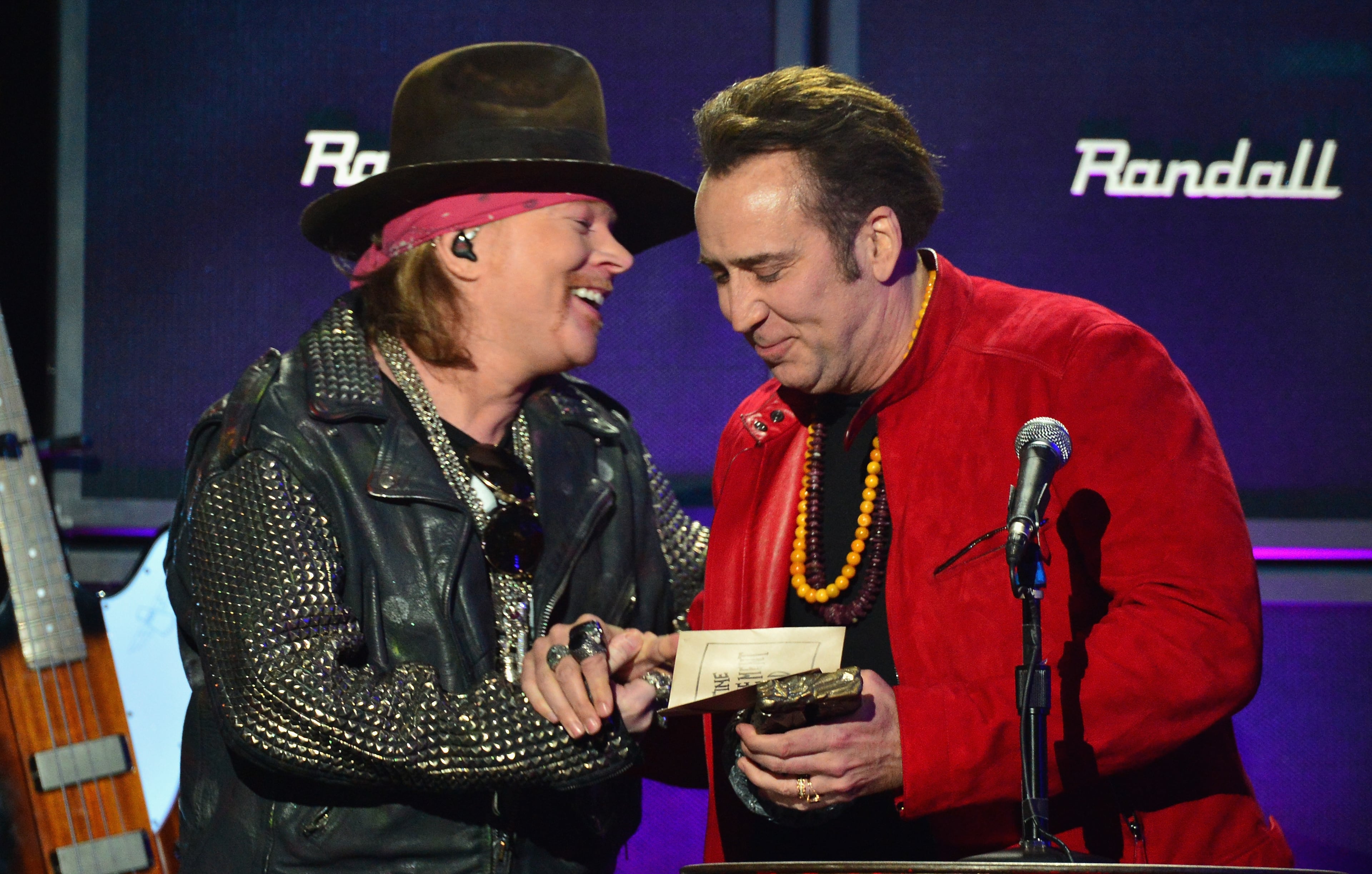 Singer Axl Rose (L) and actor Nicolas Cage speak onstage at the 2014 Revolver Golden Gods Awards at Club Nokia on April 23, 2014 in Los Angeles, California. (Photo by Frazer Harrison/Getty Images)