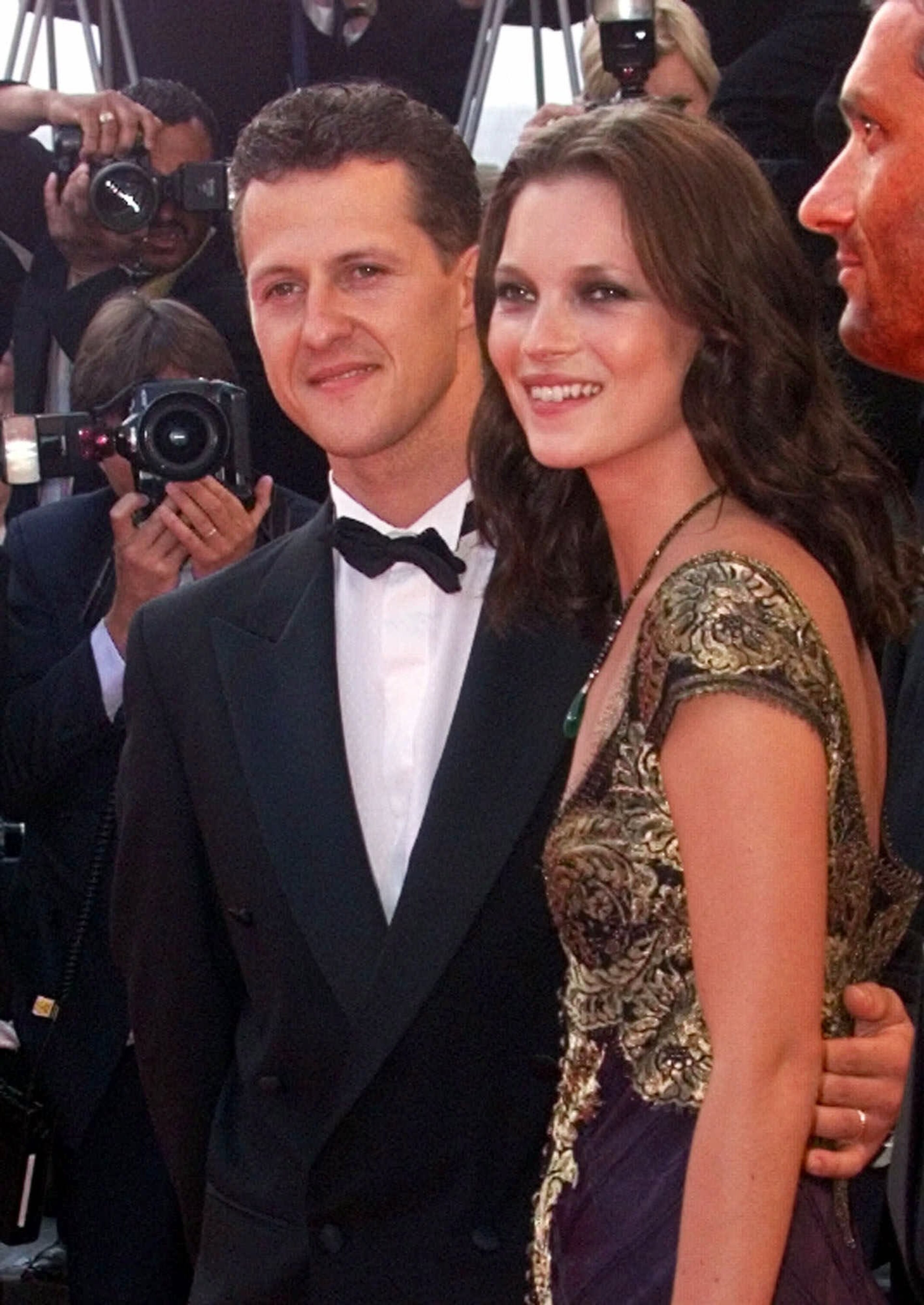 German Formula one driver Michael Schumacher arrives with British model Kate Moss for the closing ceremony of the 52nd Cannes Film Festival Sunday May 23, 1999, at Cannes, French riviera.