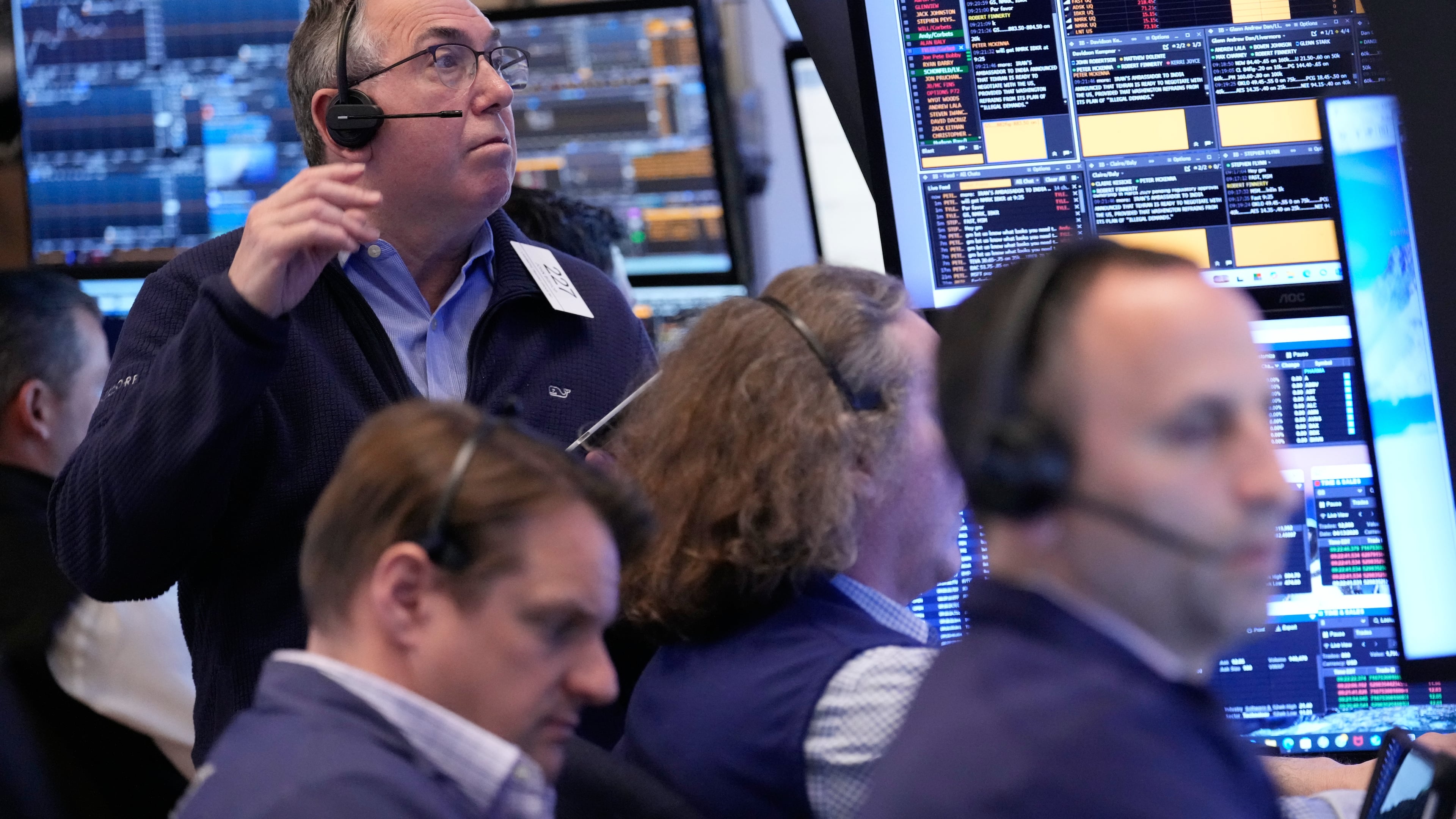 John Bishop, left, and others work on the floor at the New York Stock Exchange in New York, Monday, April 13, 2026. (AP Photo/Seth Wenig)