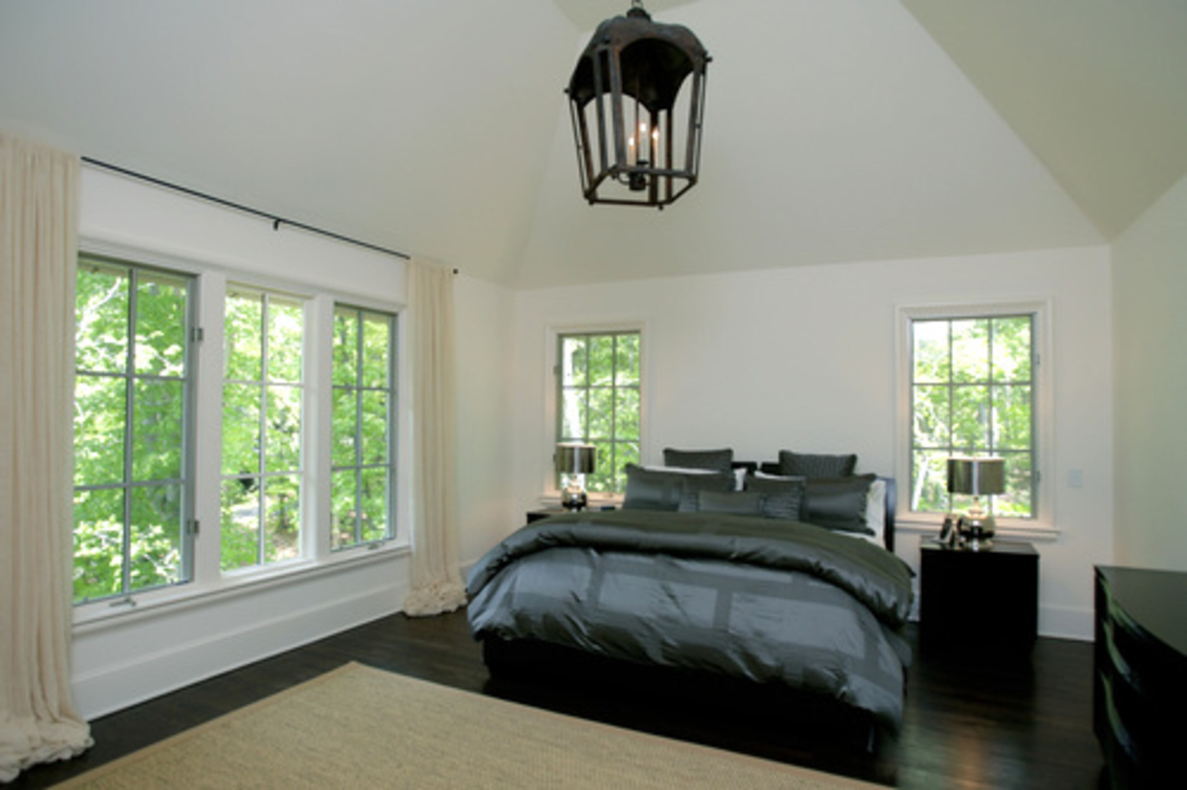 The master suite, where hand-crafted Lee Weitzman furnishings are accented in linens of steely silver, is illuminated by a vintage lantern overhead and offers Pearson plenty of room to ramble.