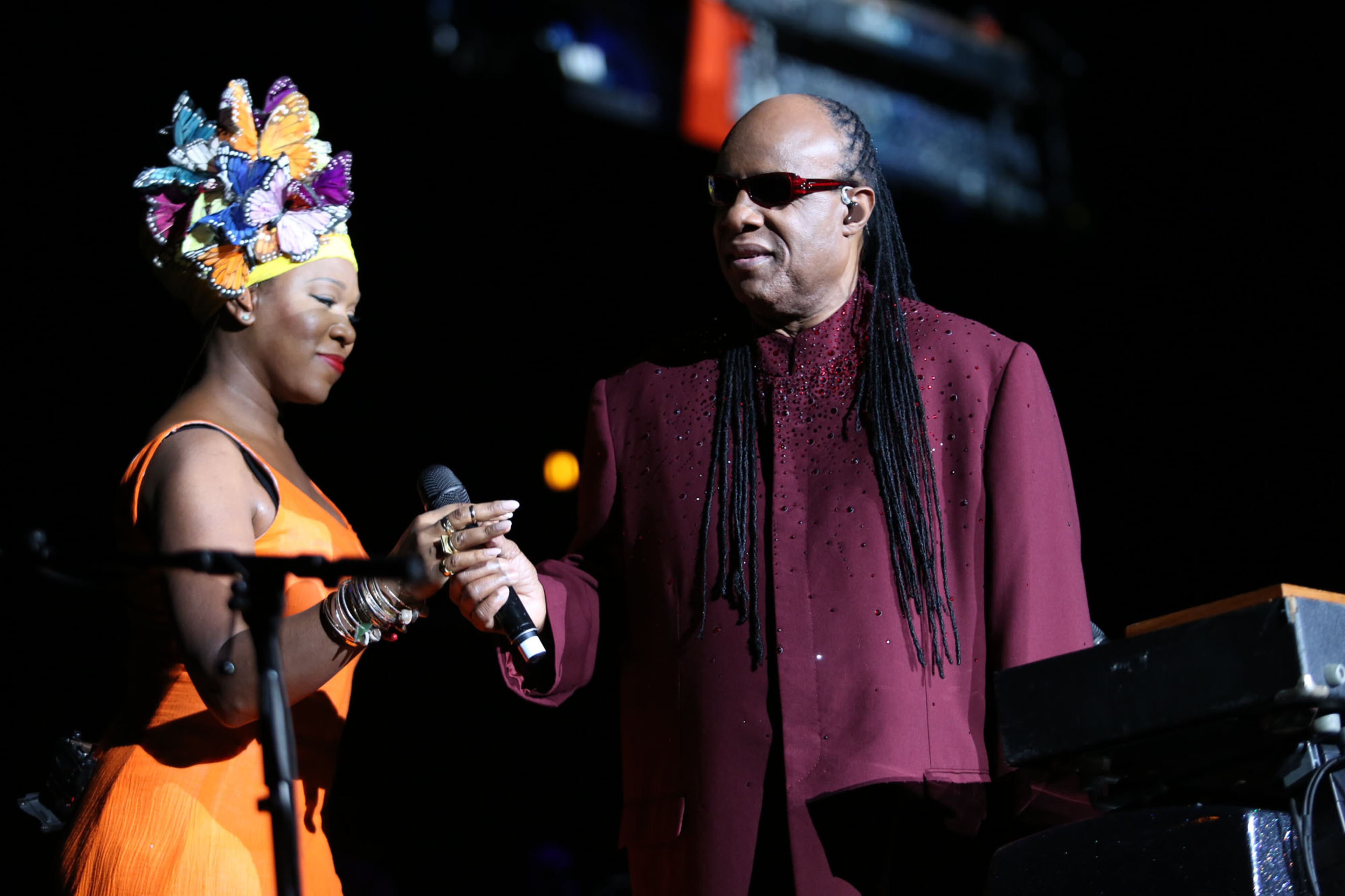 Guest vocalist India.Arie hands off a microphone to Stevie Wonder performing, "Songs in the Key of Life," at Atlanta's Philips Arena. Arie's mother Joyce is a former singer and as a teenager while signed under Motown, once opened for Stevie Wonder. Arie also cites Wonder as a major influence in her own songwriting. (Akili-Casundria Ramsess/Special to the AJC)