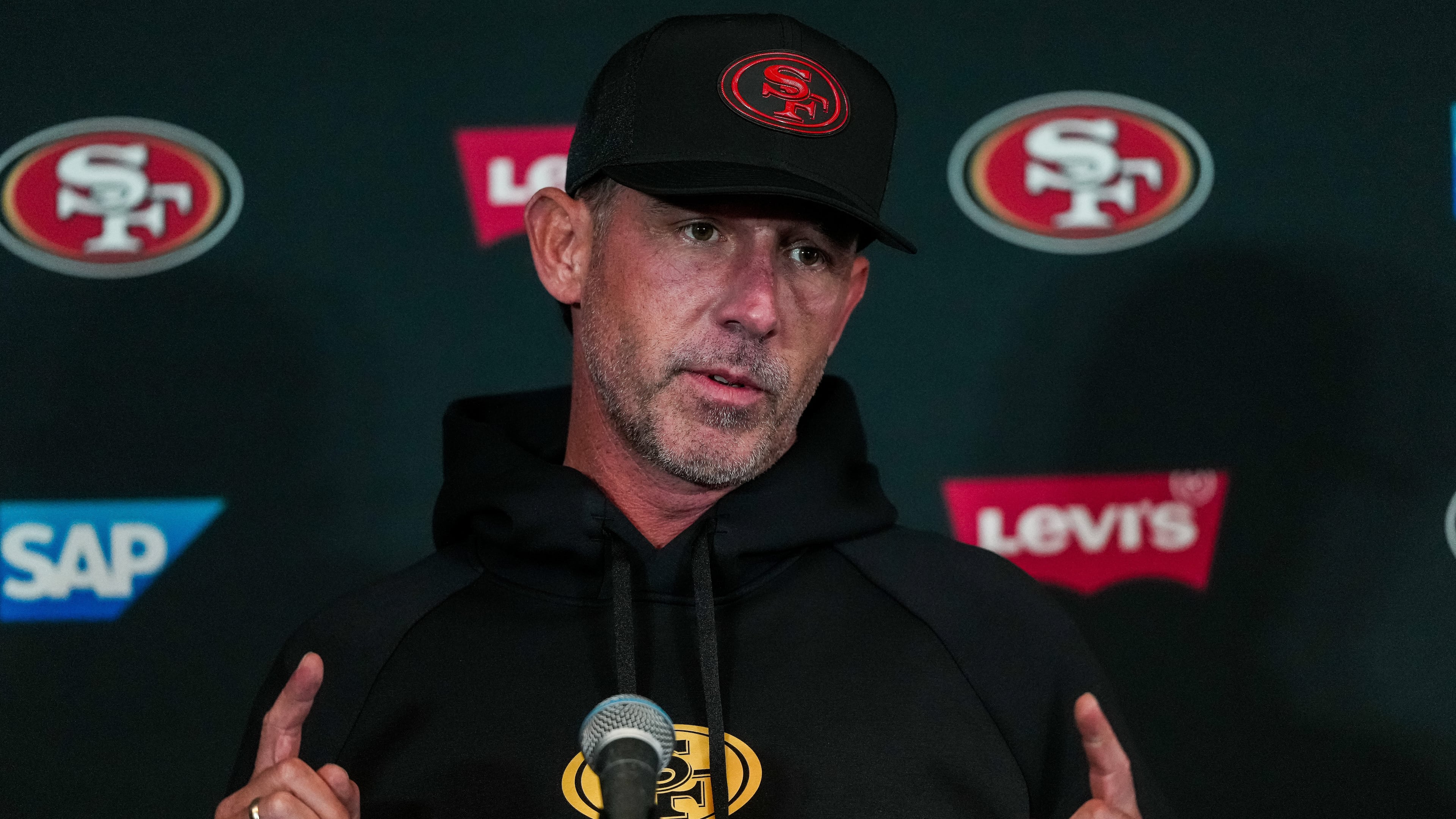 San Francisco 49ers head coach Kyle Shanahan speaks to the media ahead of practice Monday, Sept. 7, 2026, in Melbourne, Australia, in preparation for an NFL football game against the Los Angeles, Rams. (AP Photo/Asanka Brendon Ratnayake)