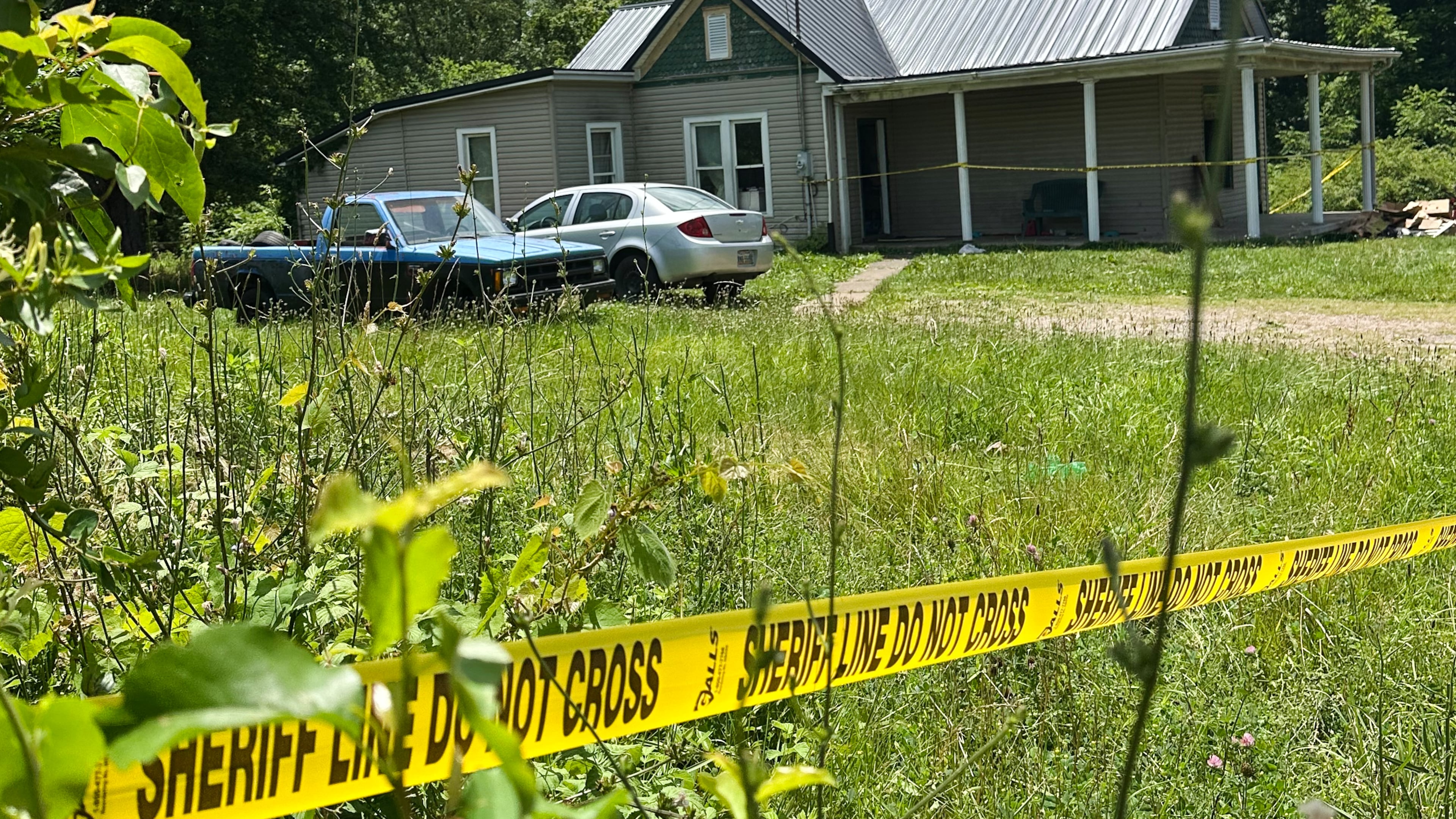 The dilapidated home where authorities say they removed 16 children and arrested four adults remains blocked off by crime scene tape on Wednesday, July 1, 2026 in Hamden, Ohio. (AP Photo/Julie Carr Smyth)