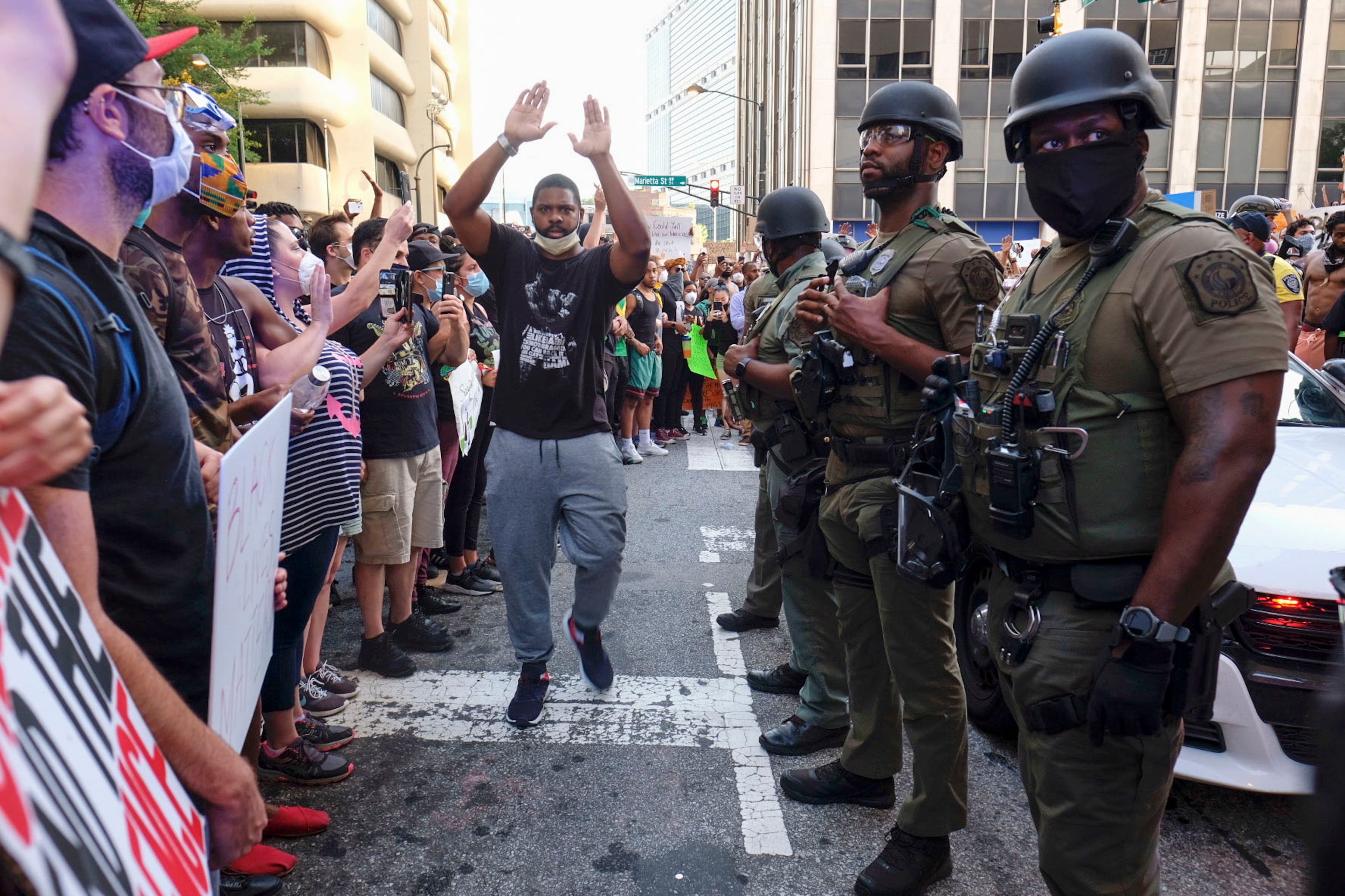 June 2, 2020 - Atlanta - Tense stand-off after homeland security officers took a protester into custody. They had to bring in a team of officers to extract the car. Could have been really bad, but the guy in yellow helped keep the crowd back a bit, and the officers did not escalate, even though they had to pull people out of the cars path Protestors in downtown Atlanta as protests continued for a fourth day. Protests over the death of George Floyd in Minneapolis police custody continued around the United States, as his case renewed anger about others involving African Americans, police and race relations. Ben Gray for the Atlanta Journal Constitution