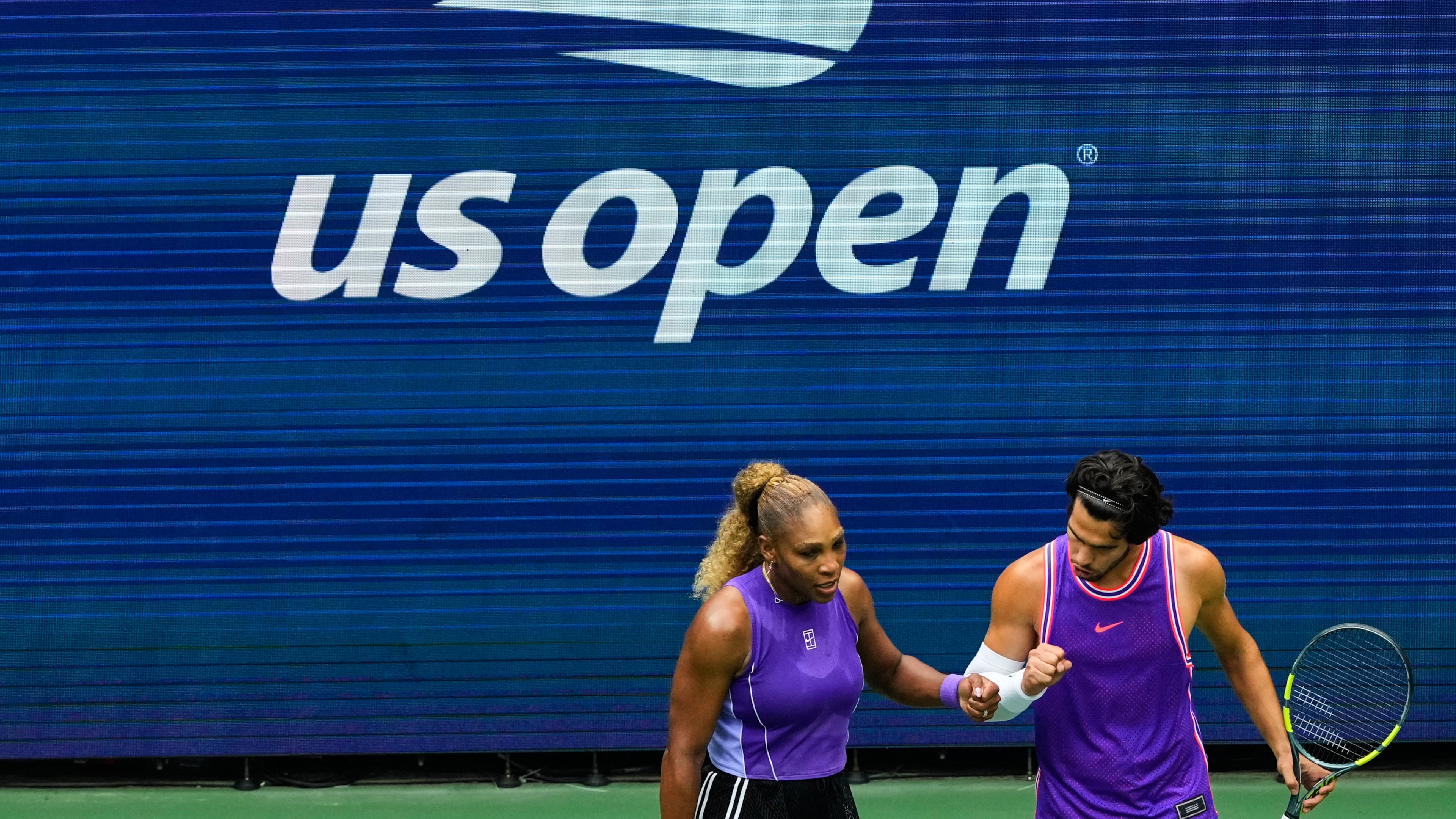 Serena Williams, of the United States, and Carlos Alcaraz, of Spain, react during a mixed doubles match at the U.S. Open tennis championships, Tuesday, Aug. 25, 2026, in New York. (AP Photo/Yuki Iwamura)