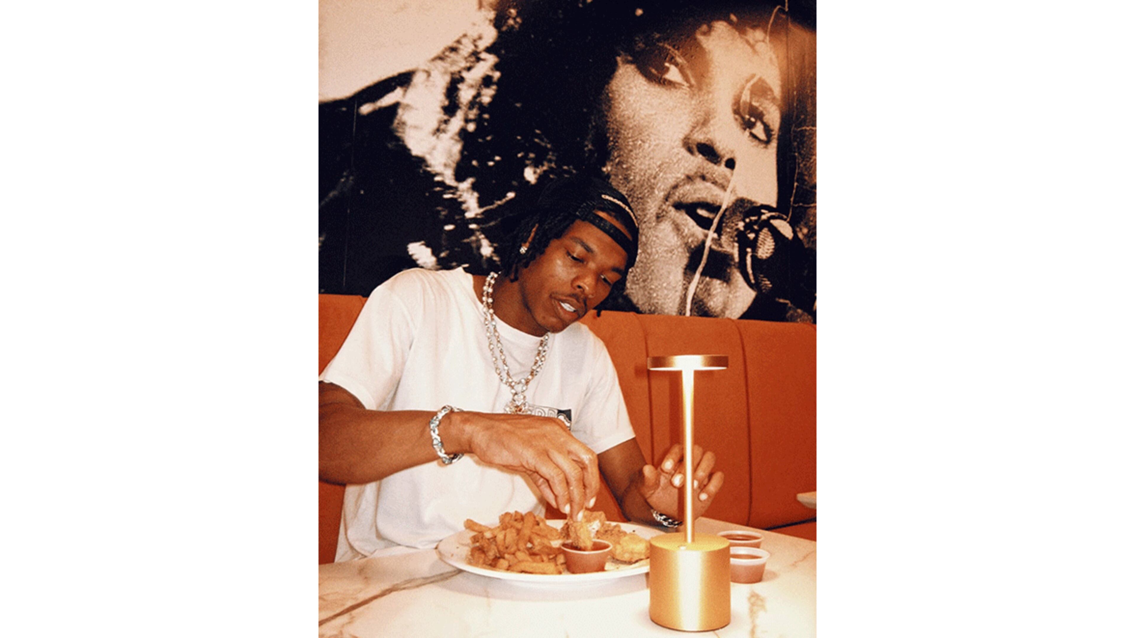 Lil Baby in his new restaurant, the Seafood Menu. / Courtesy of the Seafood Menu