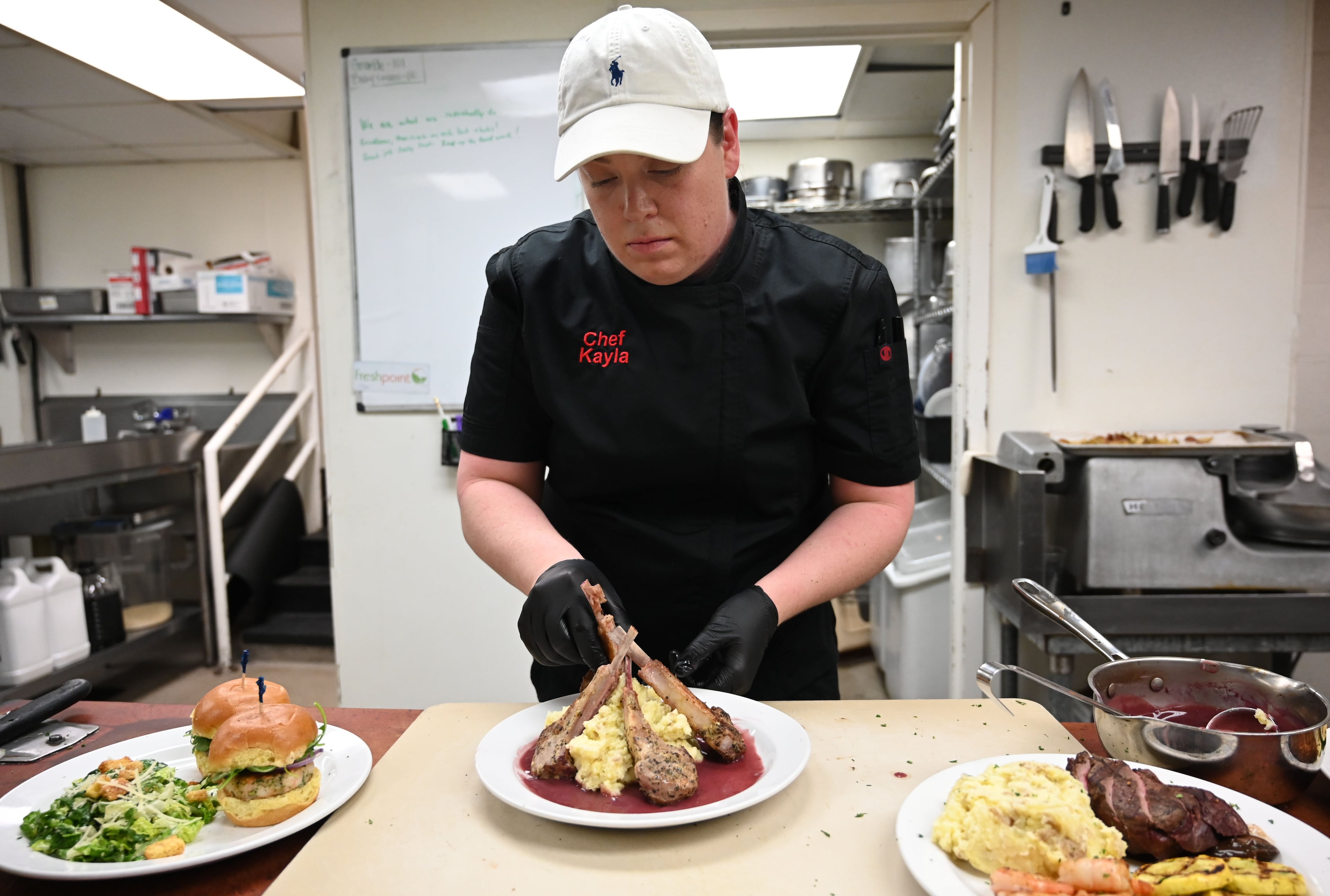 Chef Kayla Solomon-Gatti prepares food at The Swan Coach House Restaurant. Proceeds benefit the Atlanta visual arts community. (Hyosub Shin / AJC)