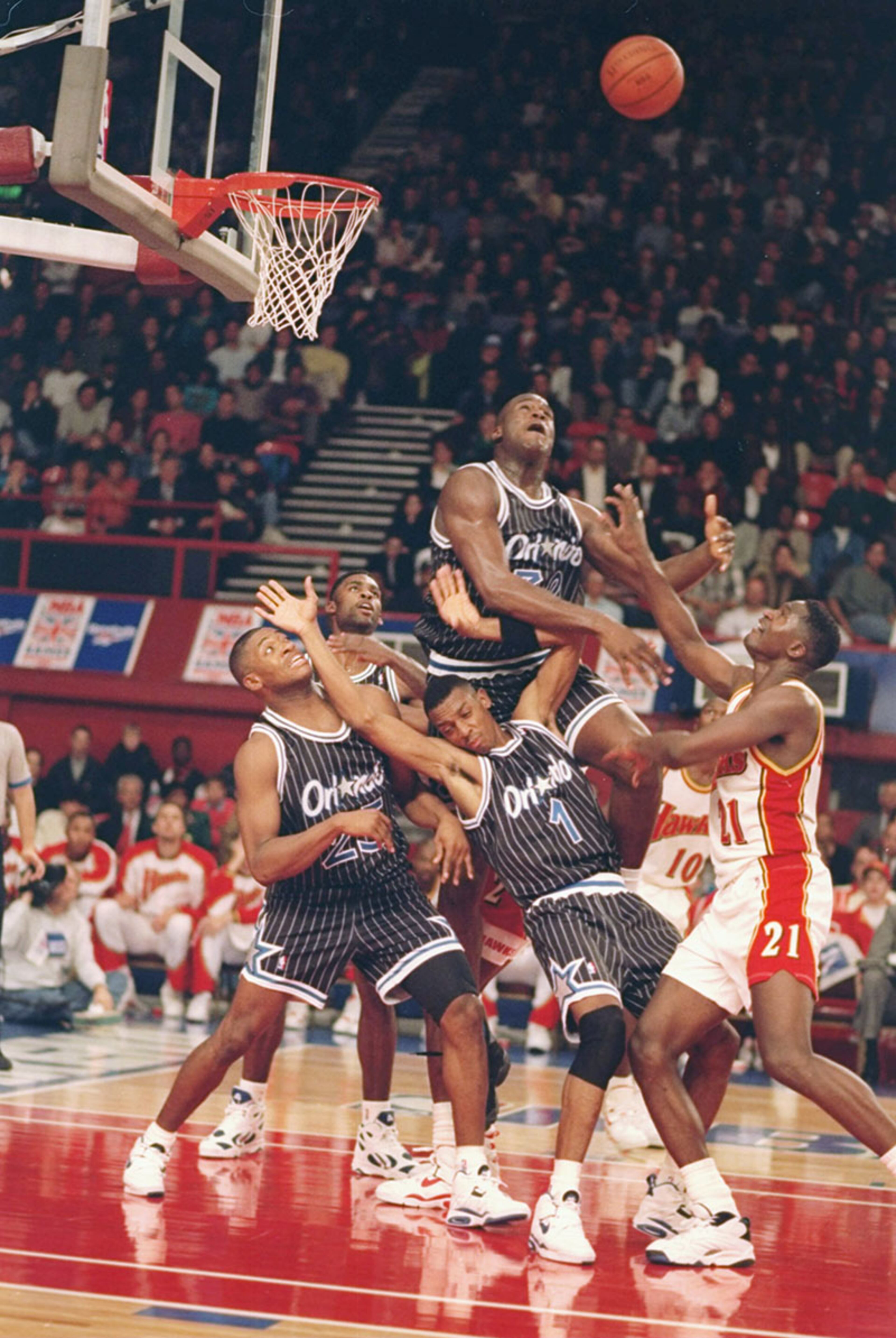 Oct. 31, 1993: Orlando's center Shaquille O'Neal out-leaps a pile of players in as the Hawks rebounded to beat the Magic 113-101 at London's Wembley Stadium.
