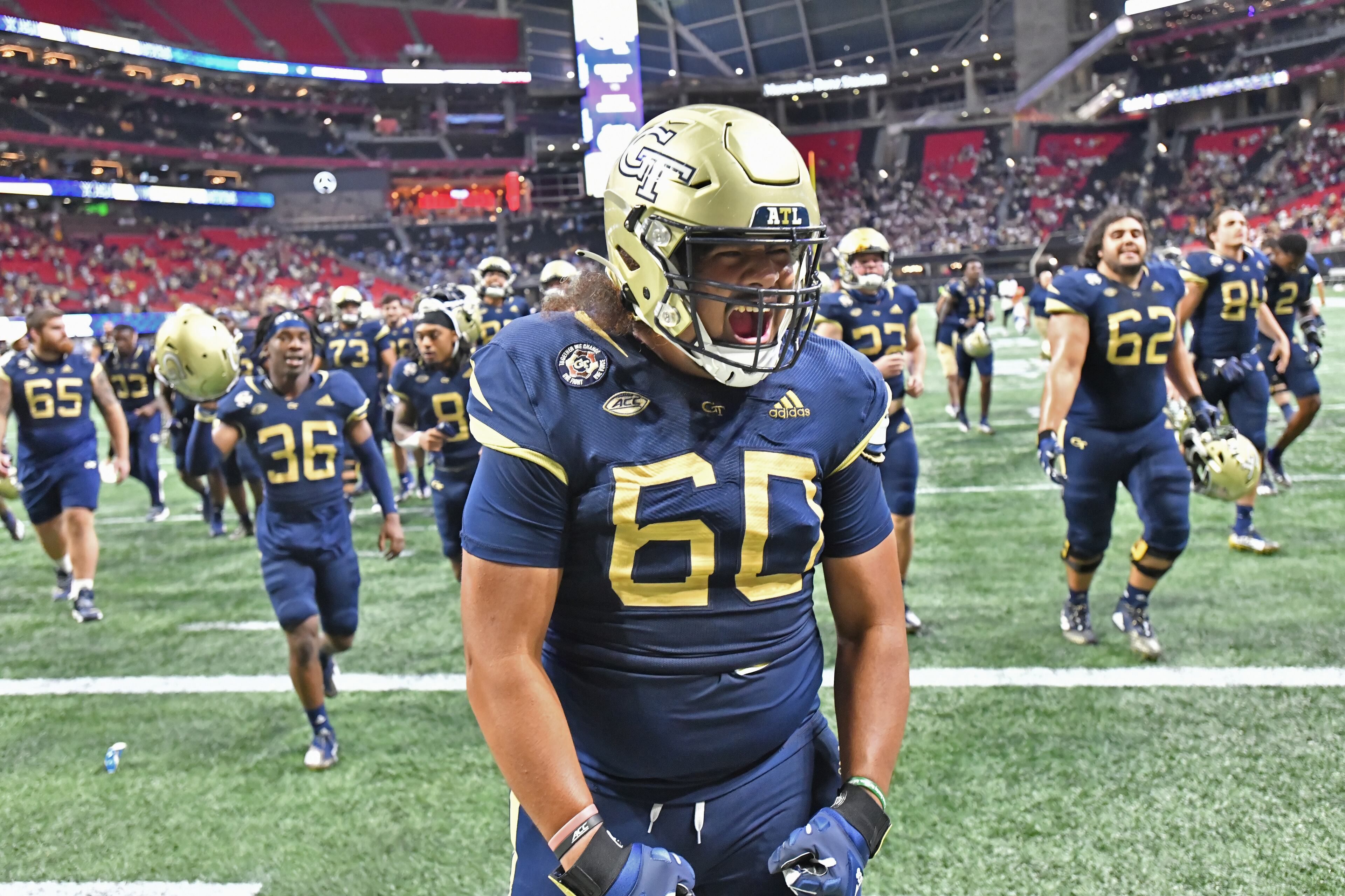 Georgia Tech's offensive lineman Paula Vaipulu (60) celebrates after the win. (Hyosub Shin / Hyosub.Shin@ajc.com)