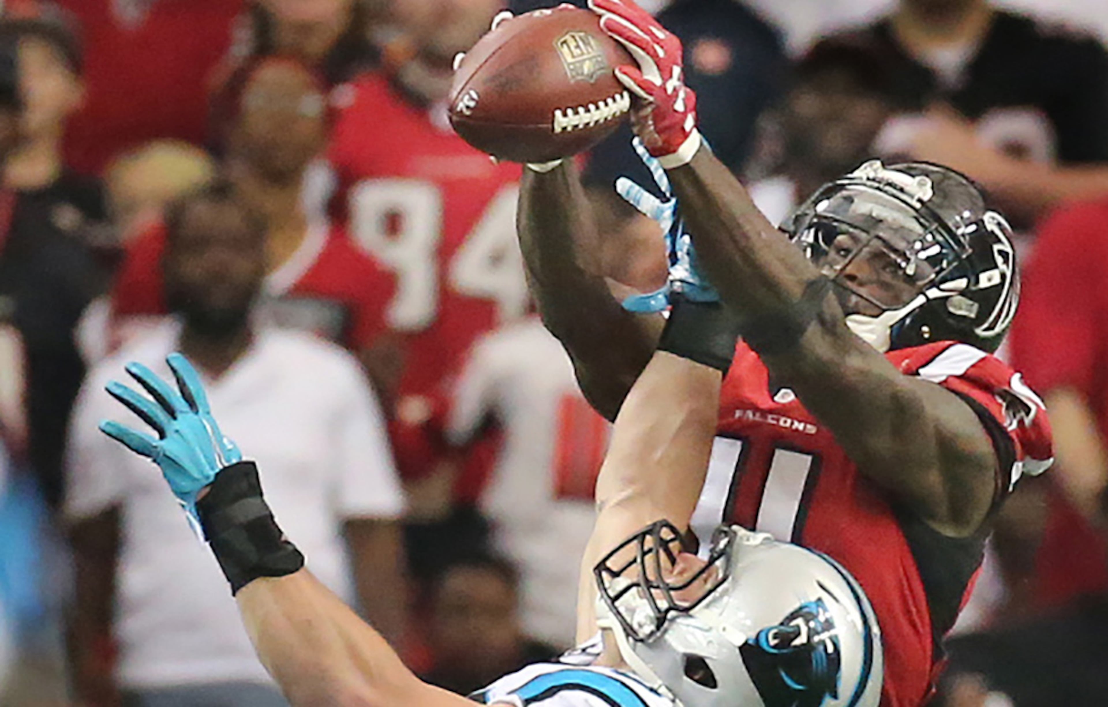 Falcons wide receiver Julio Jones goes up over Panthers linebacker Luke Kuechly for a long touchdown pass from Matt Ryan to take a 14-10 lead over the Panthers during the third quarter in a football game on Sunday, Dec. 27, 2015, in Atlanta. Curtis Compton / ccompton@ajc.com