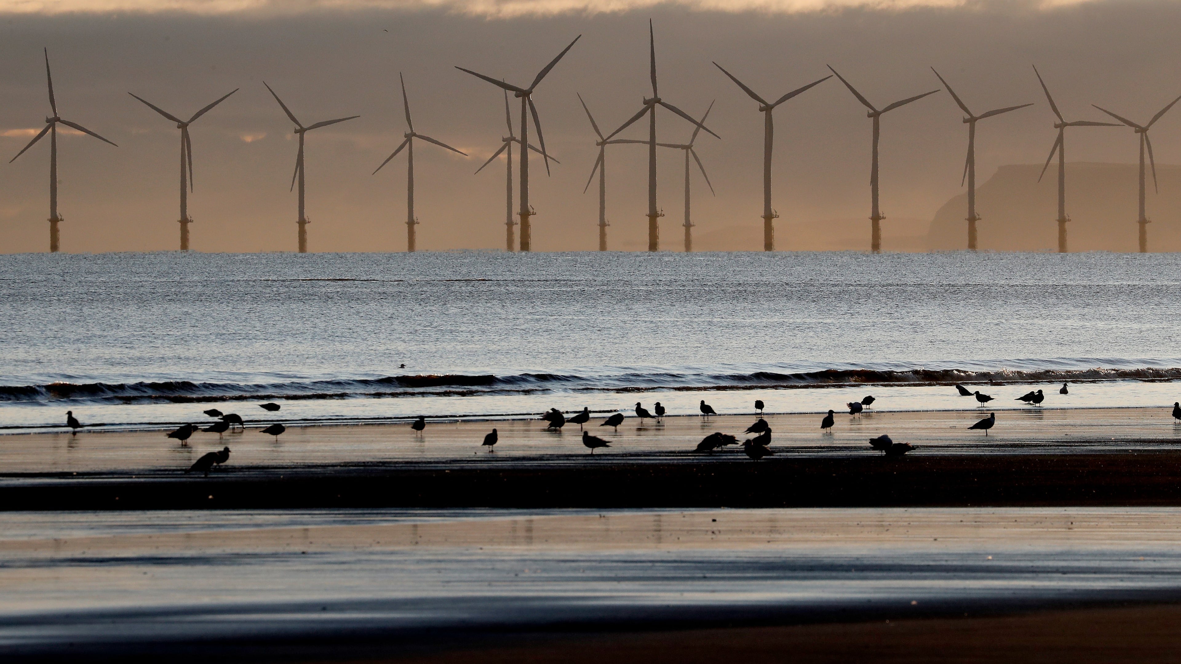 FILE - An offshore wind farm is visible from the beach in Hartlepool, England, Tuesday, Nov. 12, 2019. (AP Photo/Frank Augstein, File)