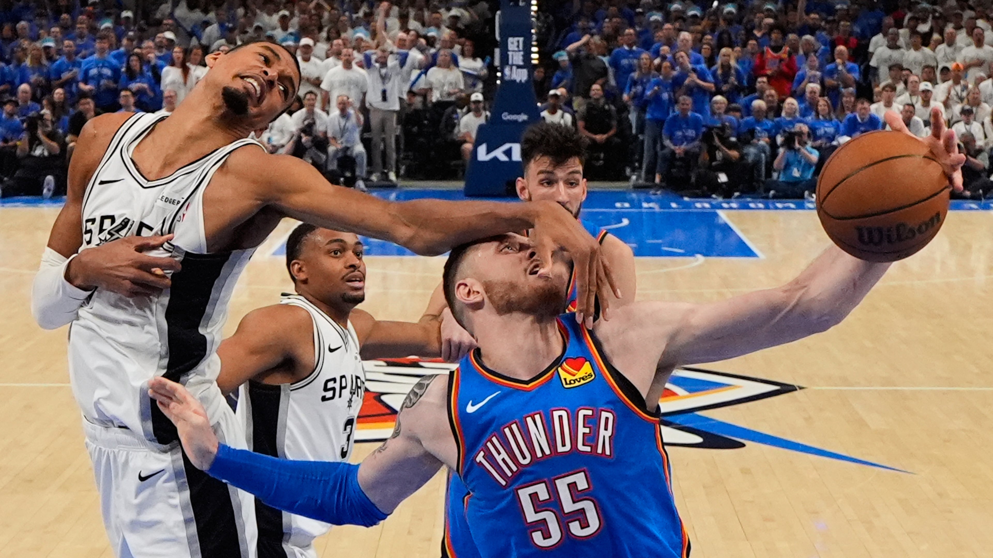 San Antonio Spurs forward Victor Wembanyama (1) defends against Oklahoma City Thunder center Isaiah Hartenstein (55) during the second half of Game 2 in the Western Conference finals NBA basketball playoffs series Wednesday, May 20, 2026, in Oklahoma City. (AP Photo/Nate Billings)