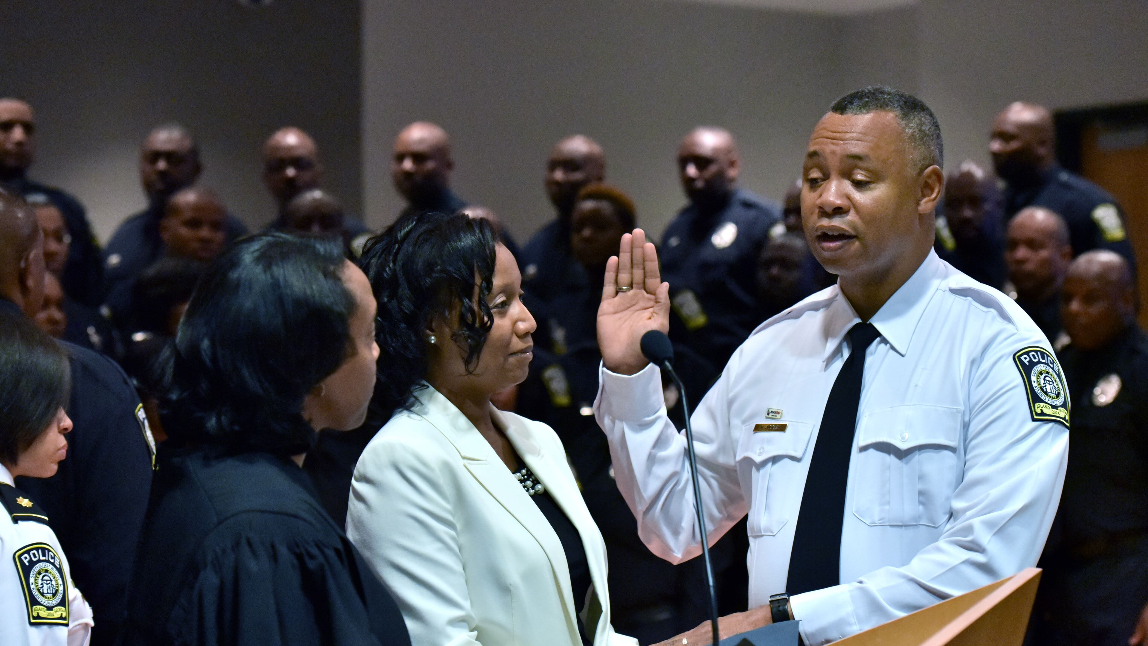 Ronald Applin is sworn in as Atlanta Public Schools police chief before Chief Magistrate Judge Cassandra Kirk in 2016. He recently requested an investigation of his police officers after cheating allegations surfaced. HYOSUB SHIN / HSHIN@AJC.COM