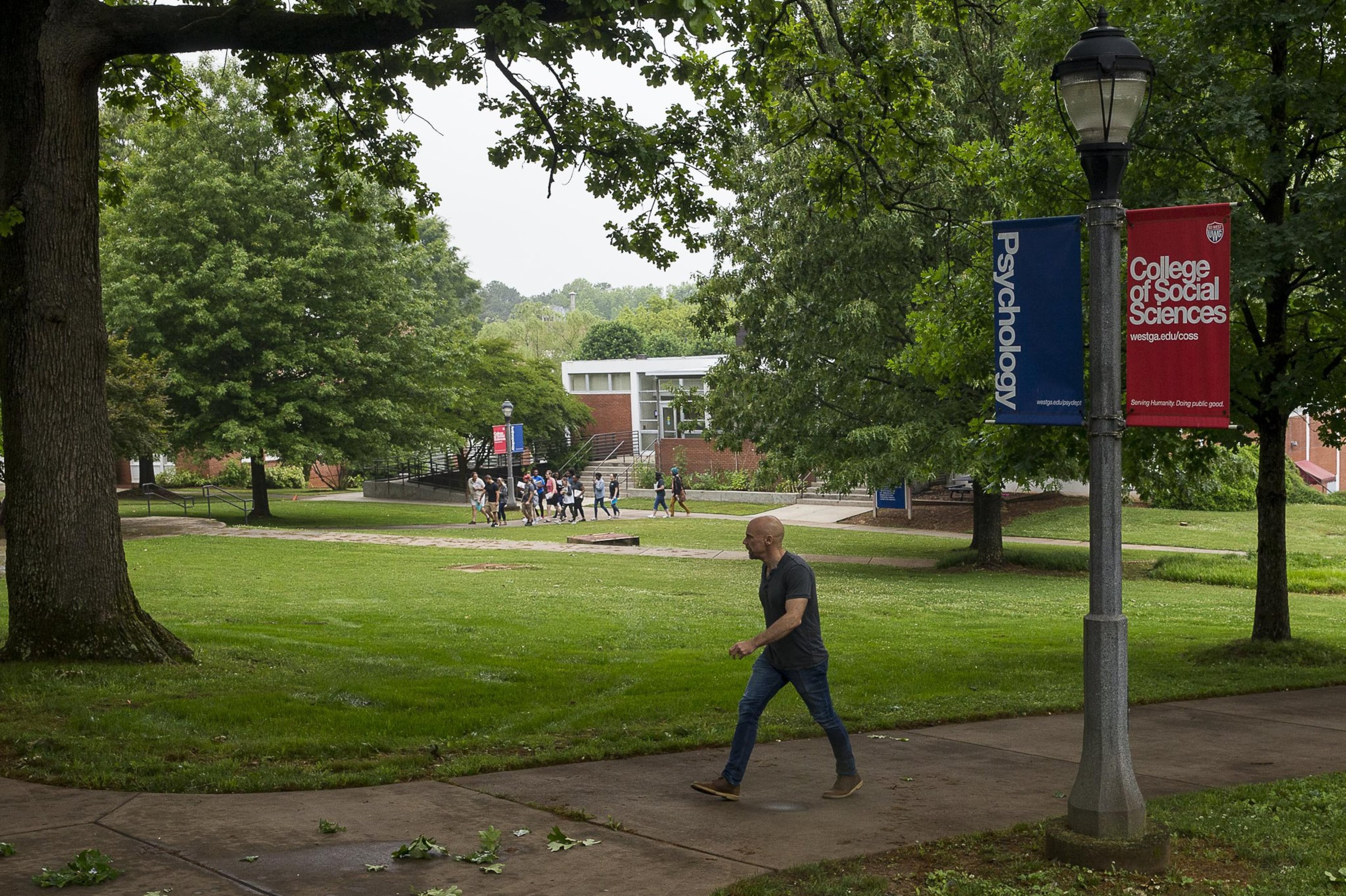 A man walks the campus at the University of West Georgia in Carrollton. The plot of land to the right of the man is where recent archaeological tests suggest slaves from a former plantation might be buried. If true, UWG will be added to a long list of colleges and communities challenged with questions on how to deal with newly discovered remains of former slaves and Reconstruction-era African Americans. (ALYSSA POINTER/ALYSSA.POINTER@AJC.COM)