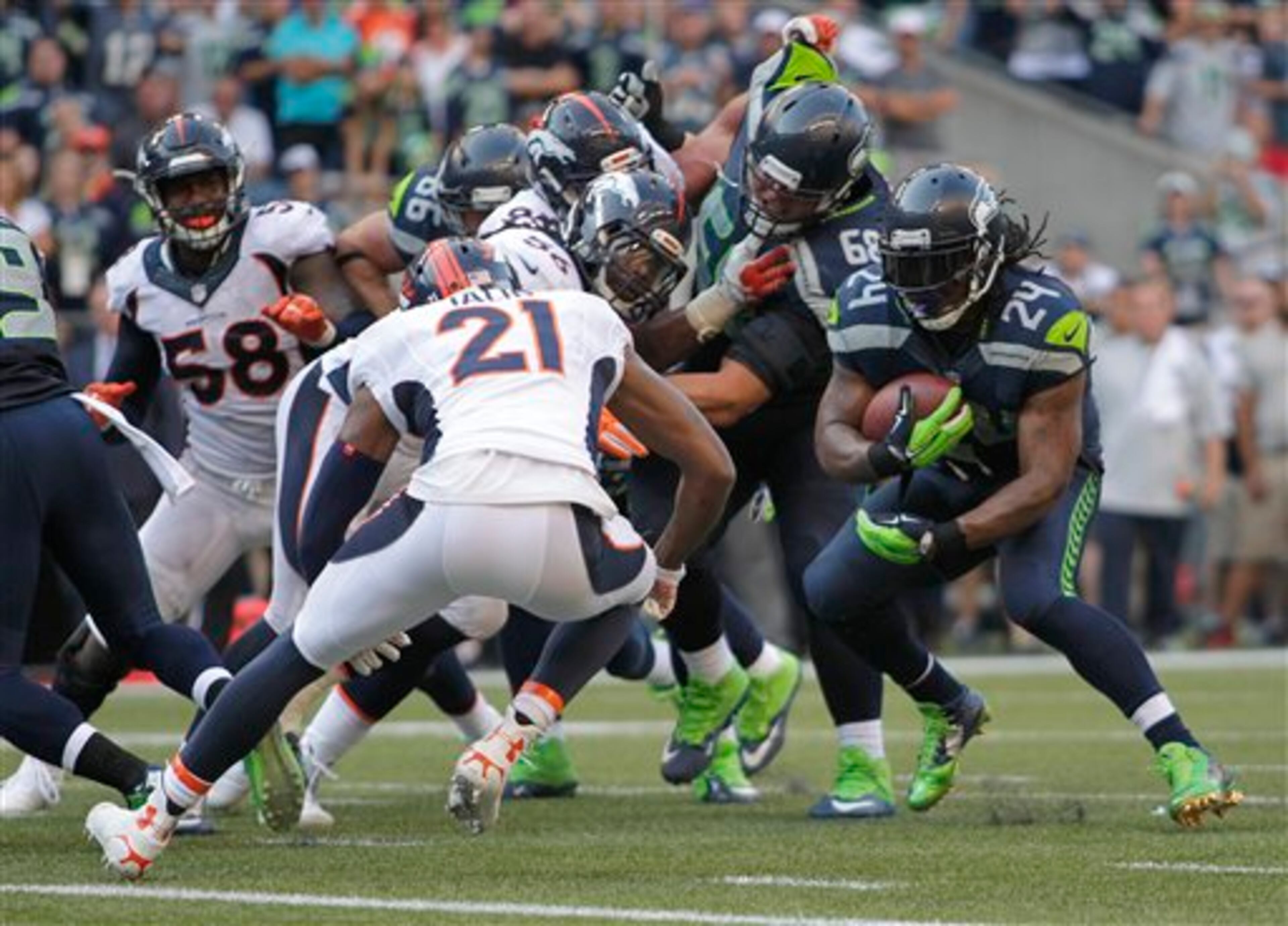 Seattle Seahawks running back Marshawn Lynch (24) runs before he dove in for the game winning touchdown in overtime of an NFL football game against the Denver Broncos, Sunday, Sept. 21, 2014, in Seattle. The Seahawks beat the Broncos 26-20. (AP Photo/John Froschauer)