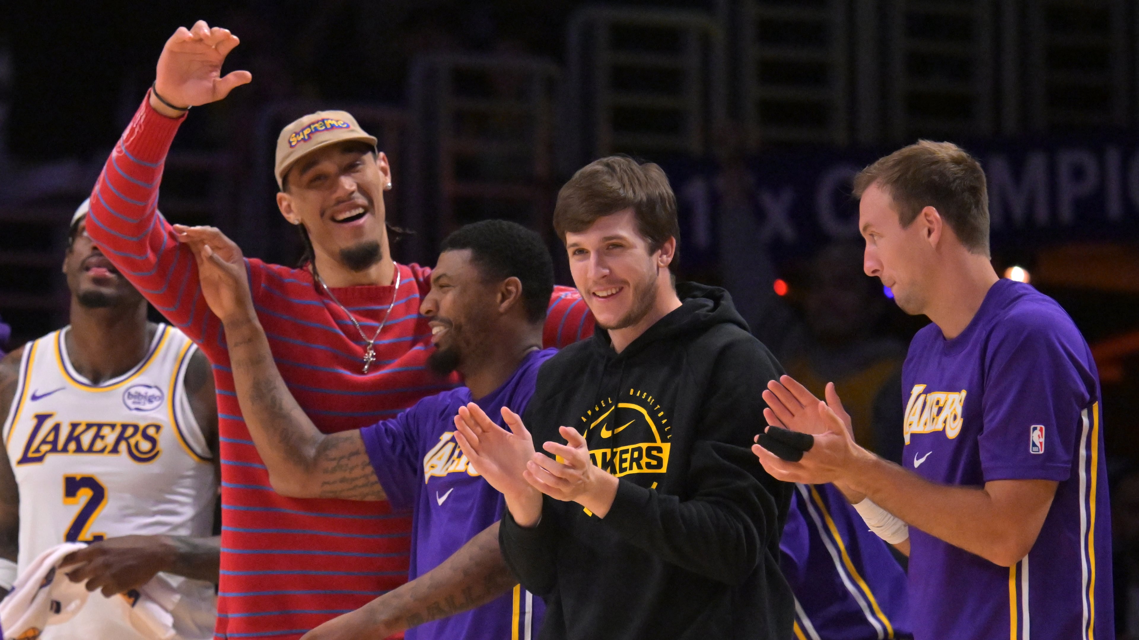 Los Angeles Lakers center Jaxson Hayes, left, Lakers' guard Marcus Smart (36), Lakers' guard Austin Reaves and guard Luke Kennard, right, react after a three-point basket by Lakers' forward Dalton Knecht (4) during the second half of an NBA basketball game against the Utah Jazz, April 12, 2026, in Los Angeles. (AP Photo/Jayne Kamin-Oncea)