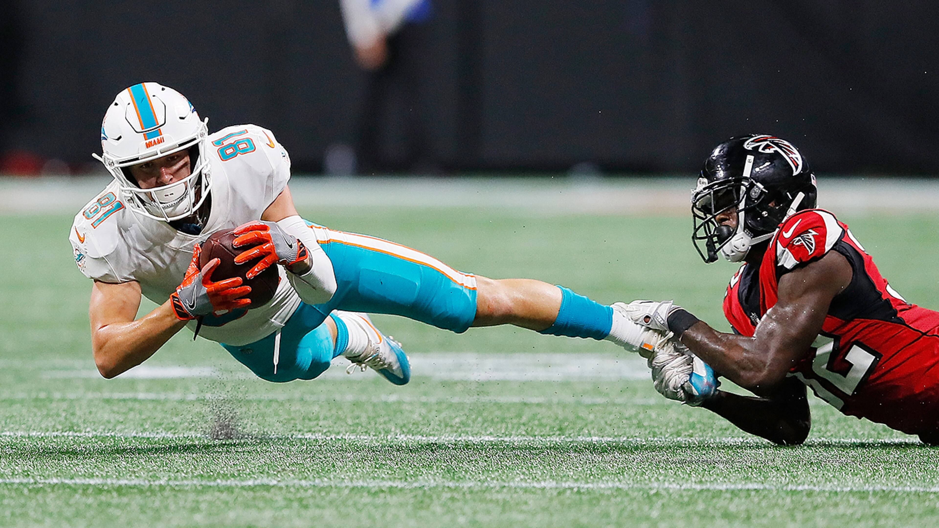 ATLANTA, GA - AUGUST 30: Drew Morgan #81 of the Miami Dolphins is tackled by Tyson Graham #32 of the Atlanta Falcons at Mercedes-Benz Stadium on August 30, 2018 in Atlanta, Georgia. (Photo by Kevin C. Cox/Getty Images)