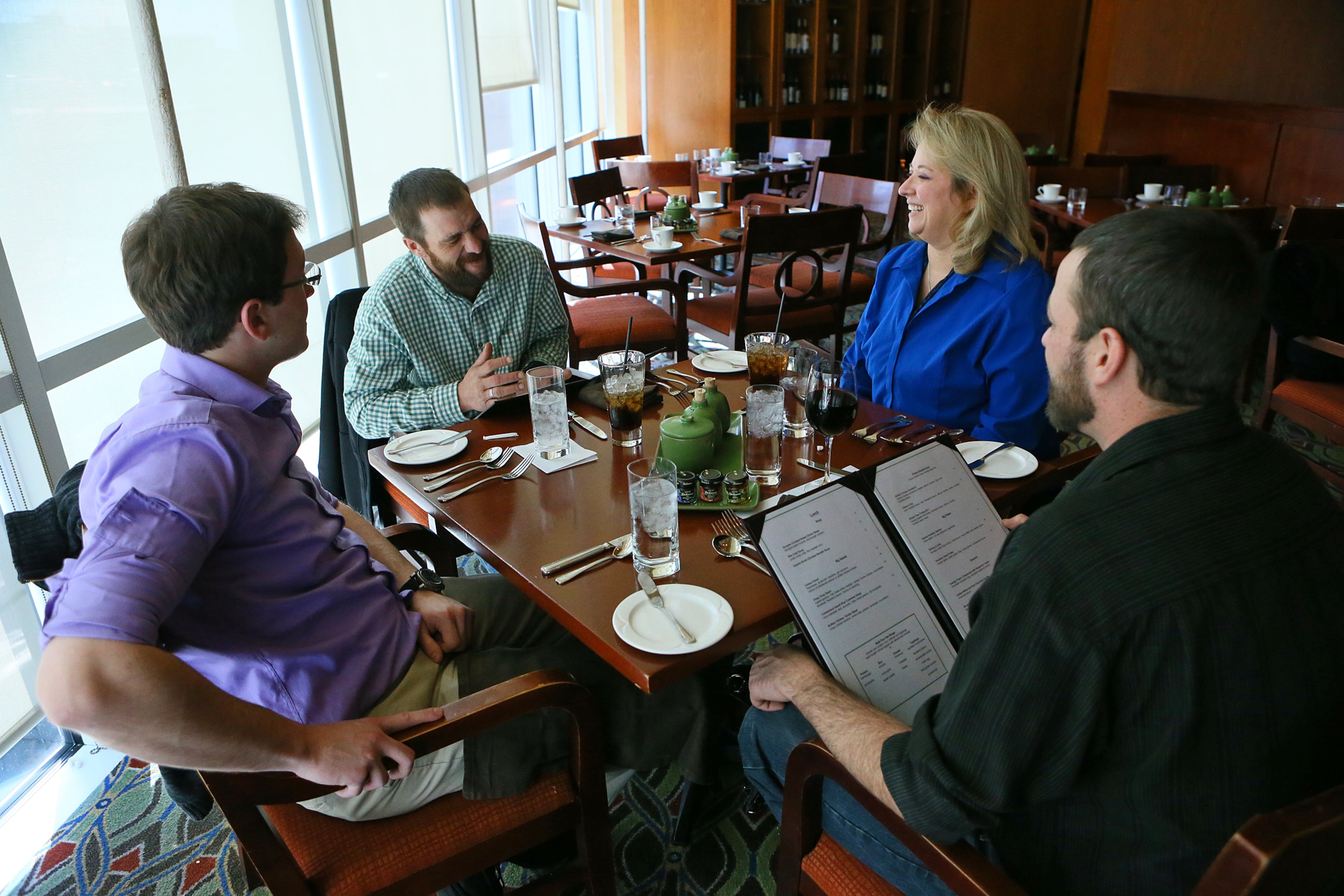 Andrew Rodecki, Joel Hartman, stepmother Deanna Rodecki, and Erick Hordos sit down for a family Thanksgiving Day meal provided by the Omni Hotel at CNN Canter on Thursday, Nov. 28, 2013, in Atlanta. His stepmother Deanna Rodecki has been searching for Hartman for more than a decade.