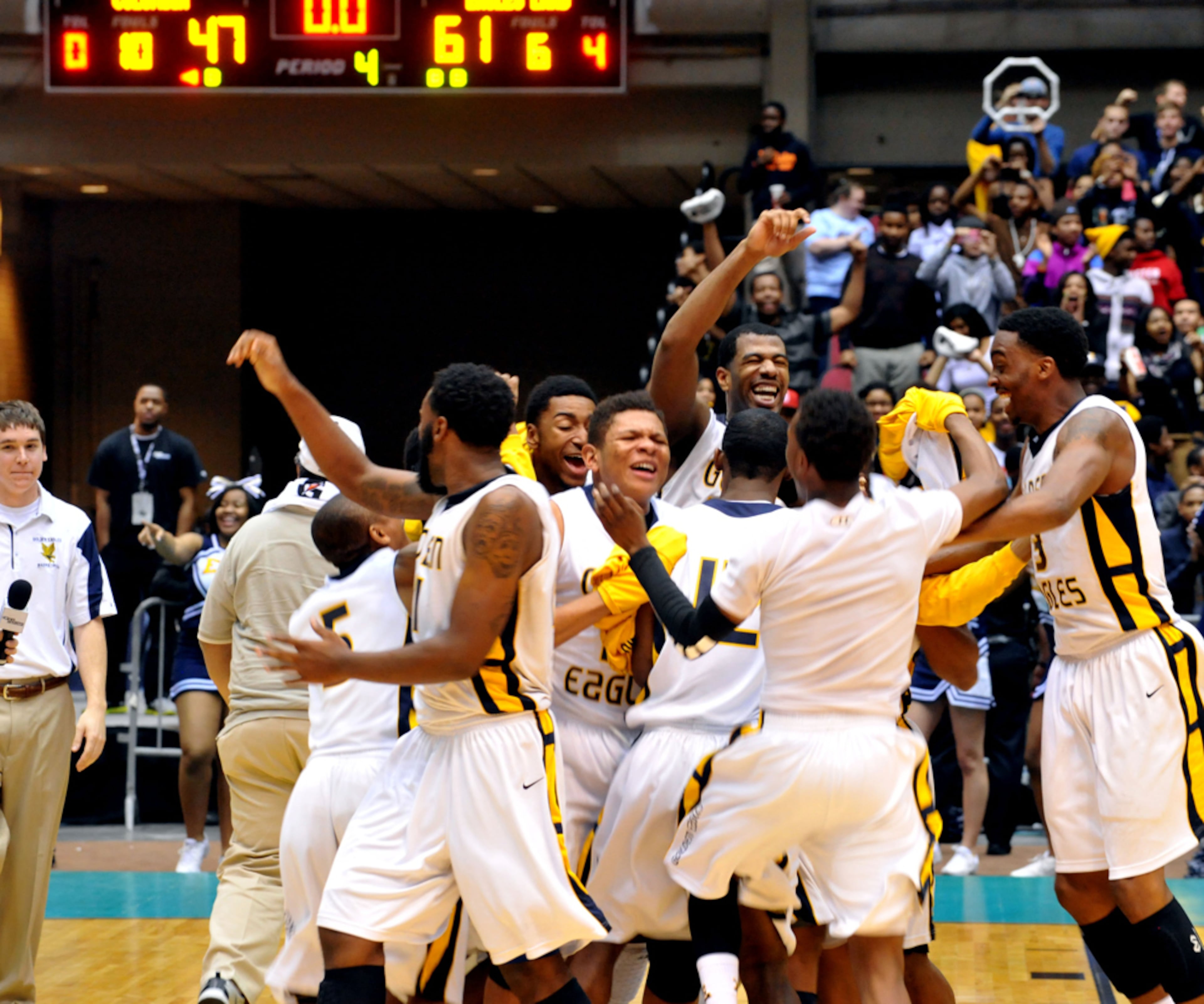 MARCH 7, 2013 MACON Eagles Landing Golden Eagles players celebrate their win over Columbia in their state AAAA boys championship game at the Macon Coliseum, Thursday, March 7, 2013. Eagles Landing beat Columbia, 61-47. KENT D. JOHNSON / KDJOHNSON@AJC.COM One of the things I like covering high school sports is the emotions of the players. Made with NIKON D3, 130mm, f/8, 1/125 sec, 4000 ISO.