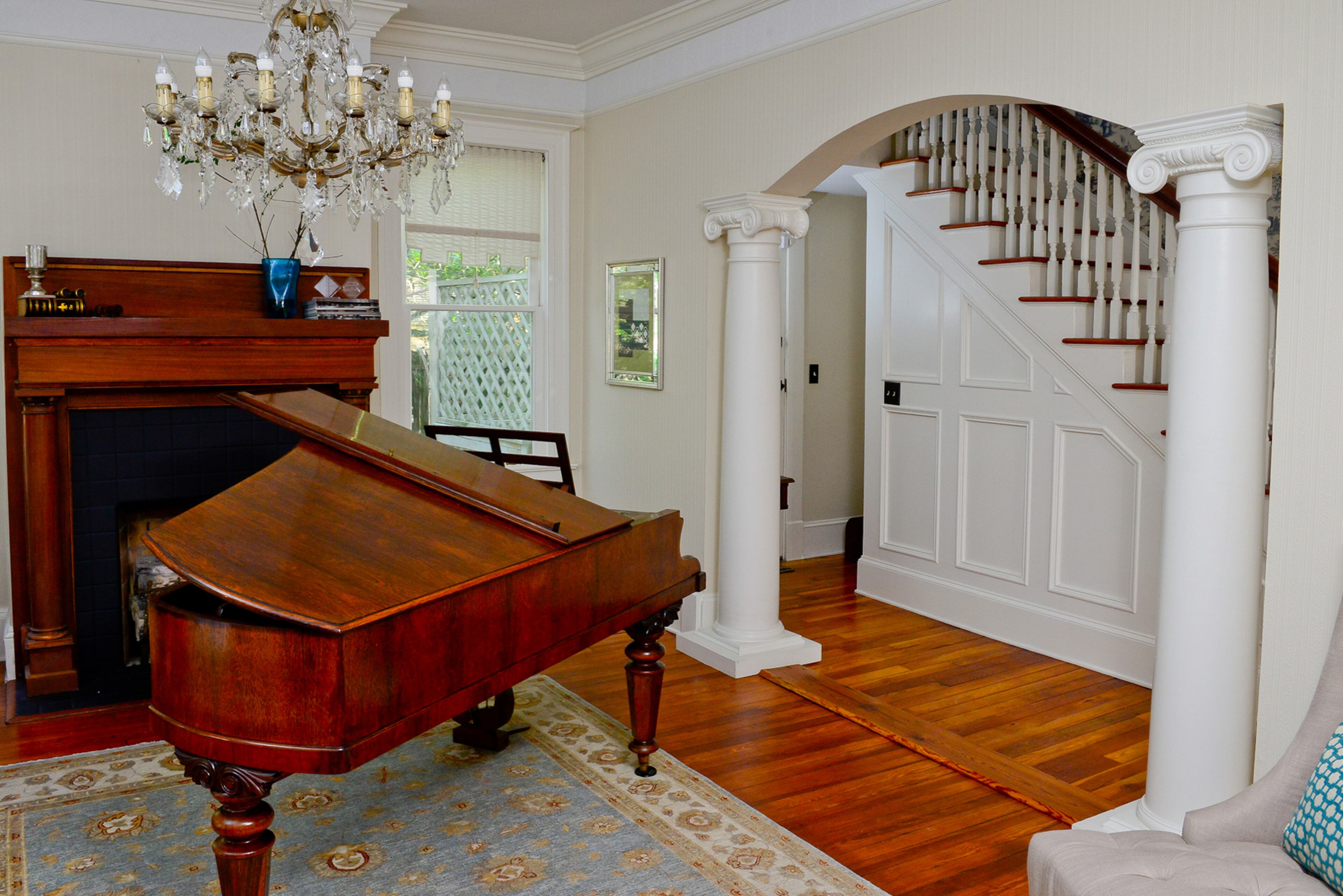 The home retains the 1920s grandeur through antiques, including a chandelier and baby grand piano near the front door. "When I'm entertaining or having a party or having people over, there's an entryway room where I can greet folks," homeowner Cromwell Baun said. "A lot of old homes in the neighborhood have the front door open up to the living room. It had an entire room which was an entry foyer." (Christopher Michael Oquendo/ www.ophotography.com )