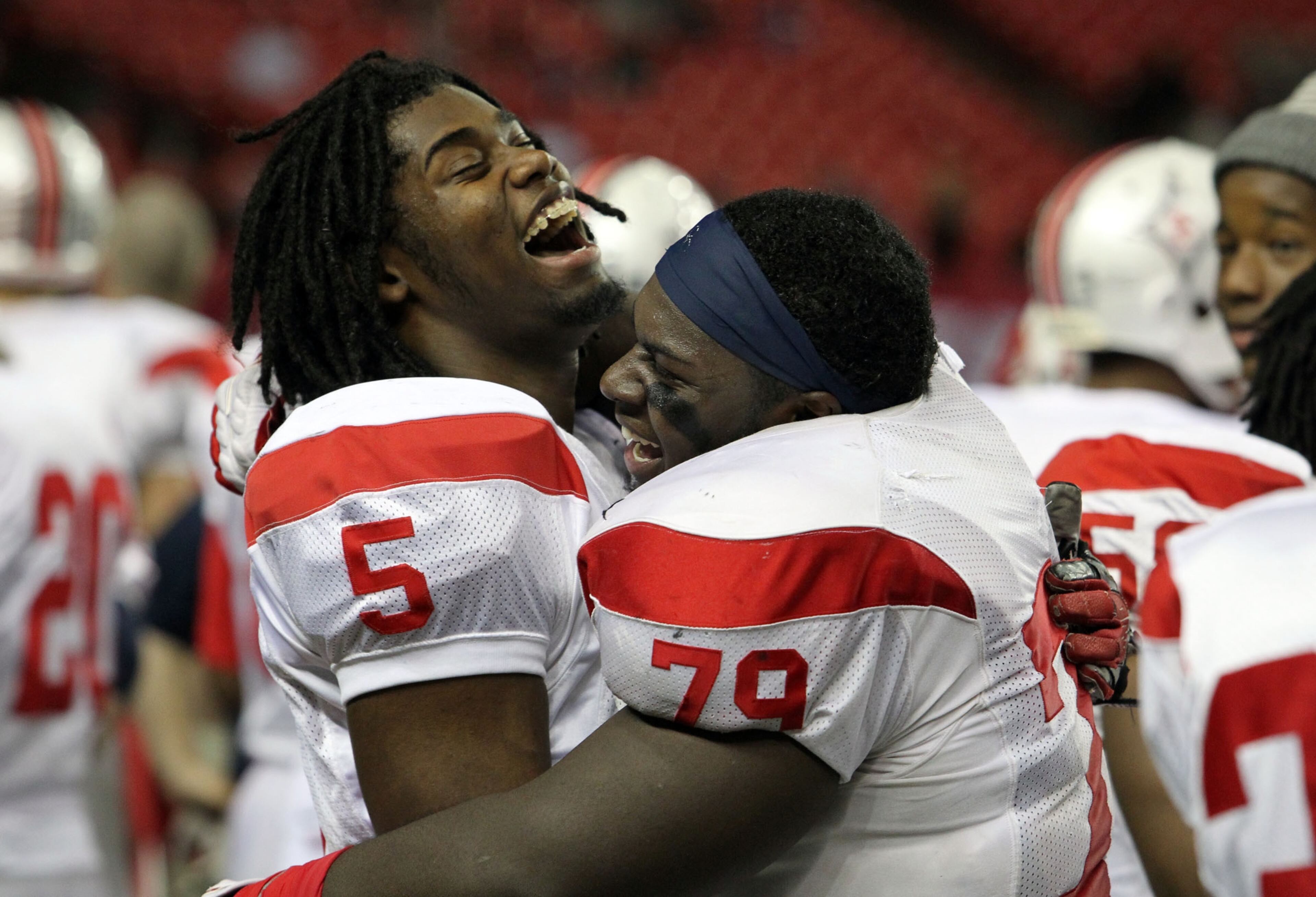 Sandy Creek's Josh Branom (left) and Issac Saxon celebrate the program's third state title in last four years.