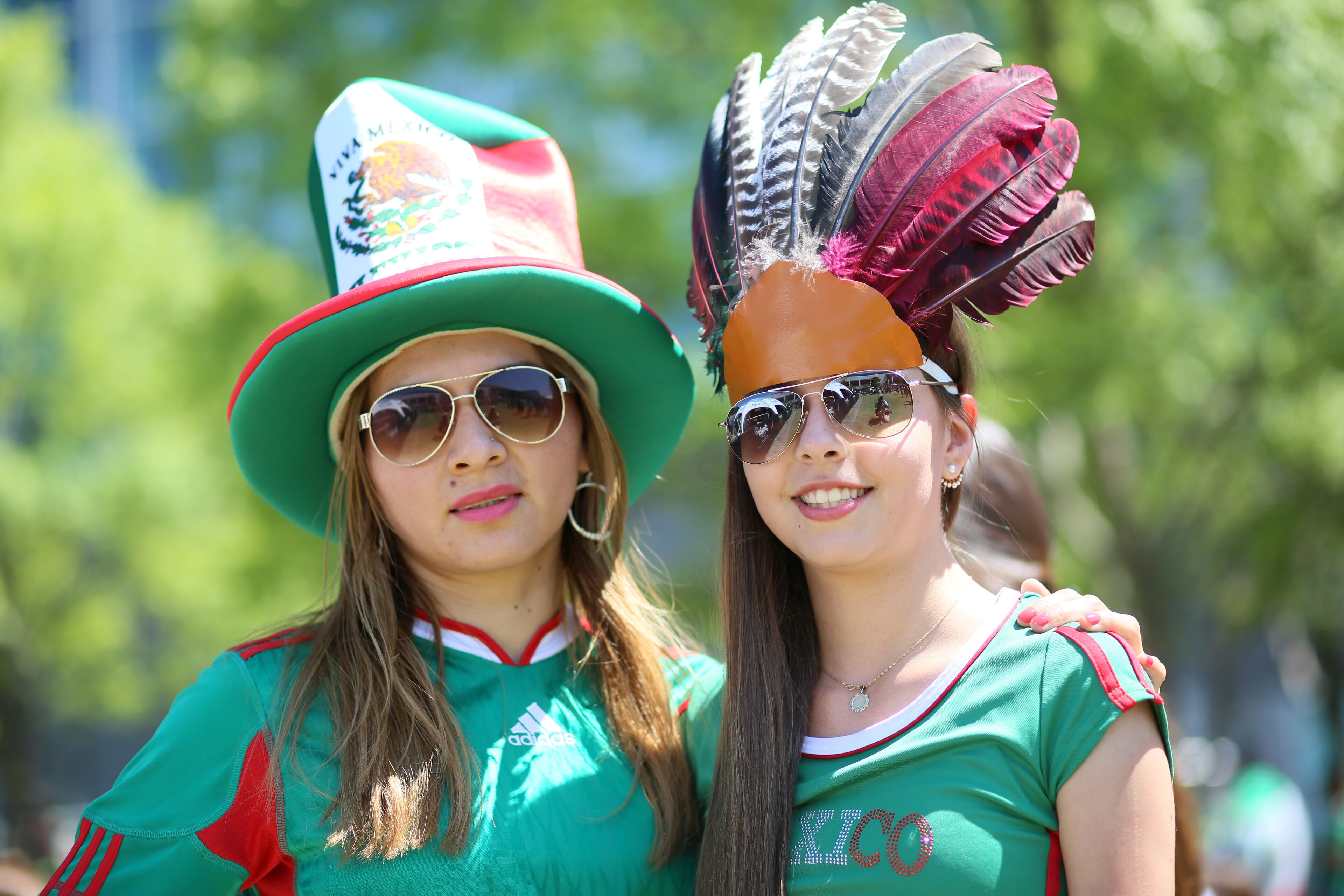 Rosario PiƱa and Marisol Parra, from Atlanta, show outfits with Mexican colors. It's the first time they've been able to see Mexico play soccer. Photo by Miguel Martinez / Mundo Hispanico