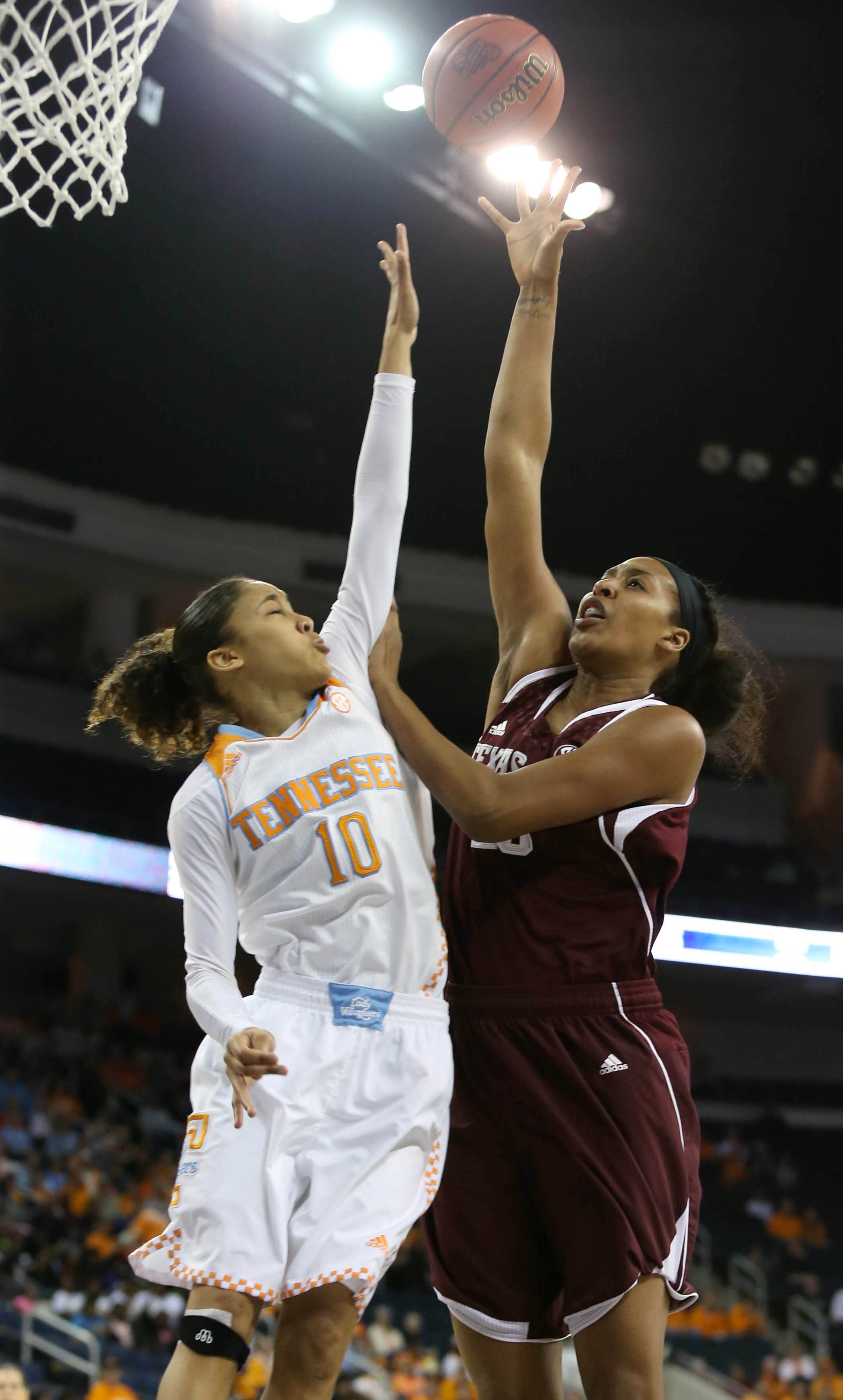 Tennessee guard Meighan Simmons (10) defends a shot by Texas A&M center Rachel Mitchell (23) during Tennessee's win over Texas A&M in the fourth-round of the Women's Southeastern Conference NCAA college basketball game, Saturday, March 8, 2014, in Duluth, Ga. Tennessee defeated Texas A&M 86-77. (AP Photo/Jason Getz)