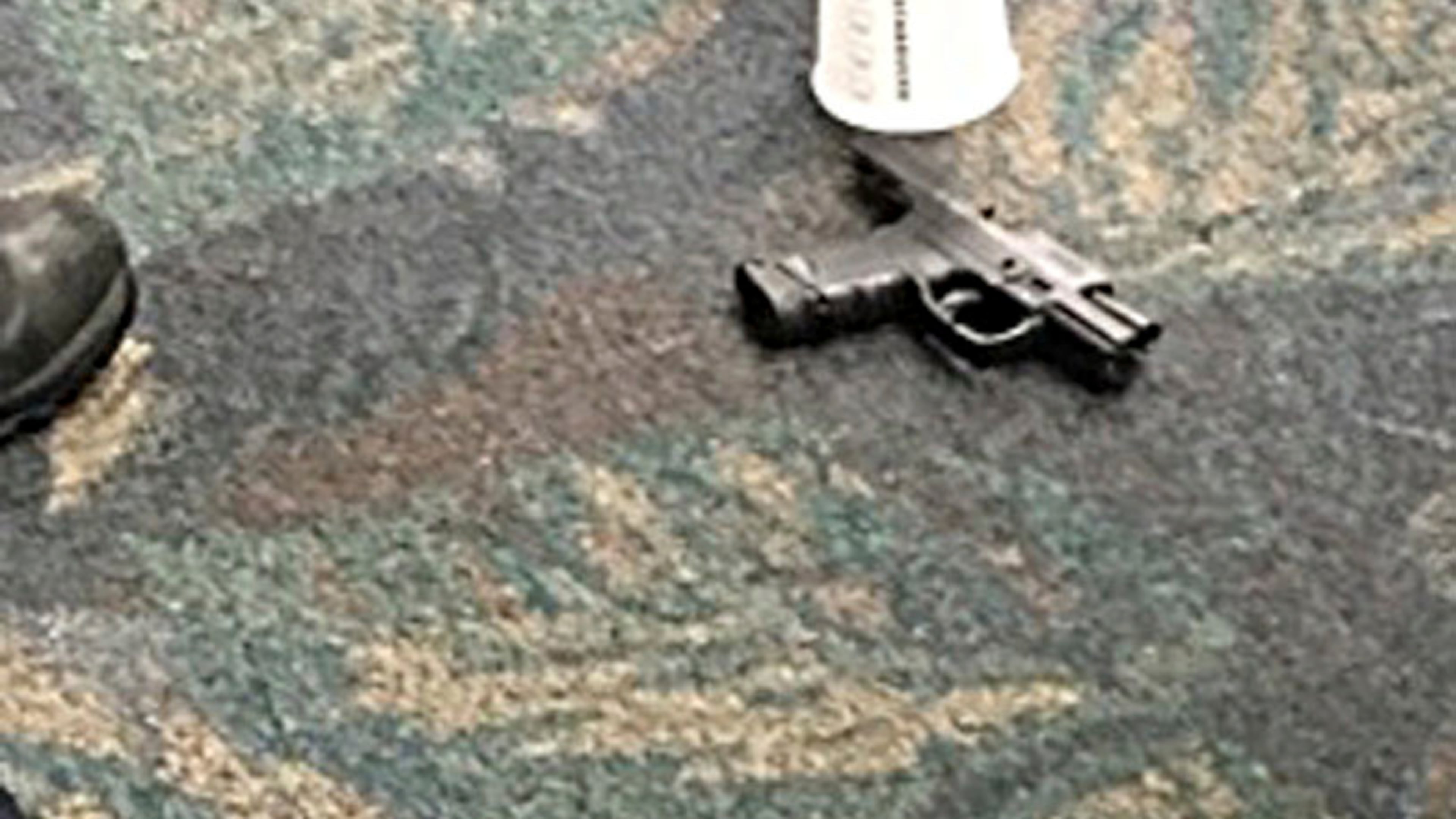 In this image taken Friday, Jan. 6, 2017 and made available by Mark Lea, shows the pistol of alleged shooter Esteban Santiago at the Ft. Lauderdale-Hollywood International Airport. Santiago opened fire in the baggage claim area killing five travelers. (Mark Lea via AP)