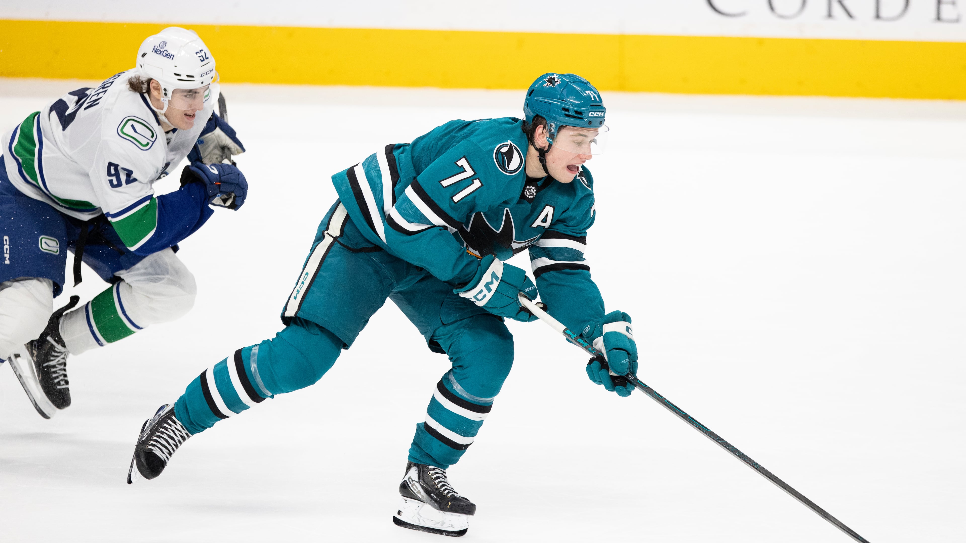 FILE - San Jose Sharks center Macklin Celebrini (71) drives the puck as Vancouver Canucks left wing Liam Ohgren (92) defends during the third period of their NHL ice hockey game in San Jose, Calif., Saturday, April 11, 2026. (Stephen Lam/San Francisco Chronicle via AP)