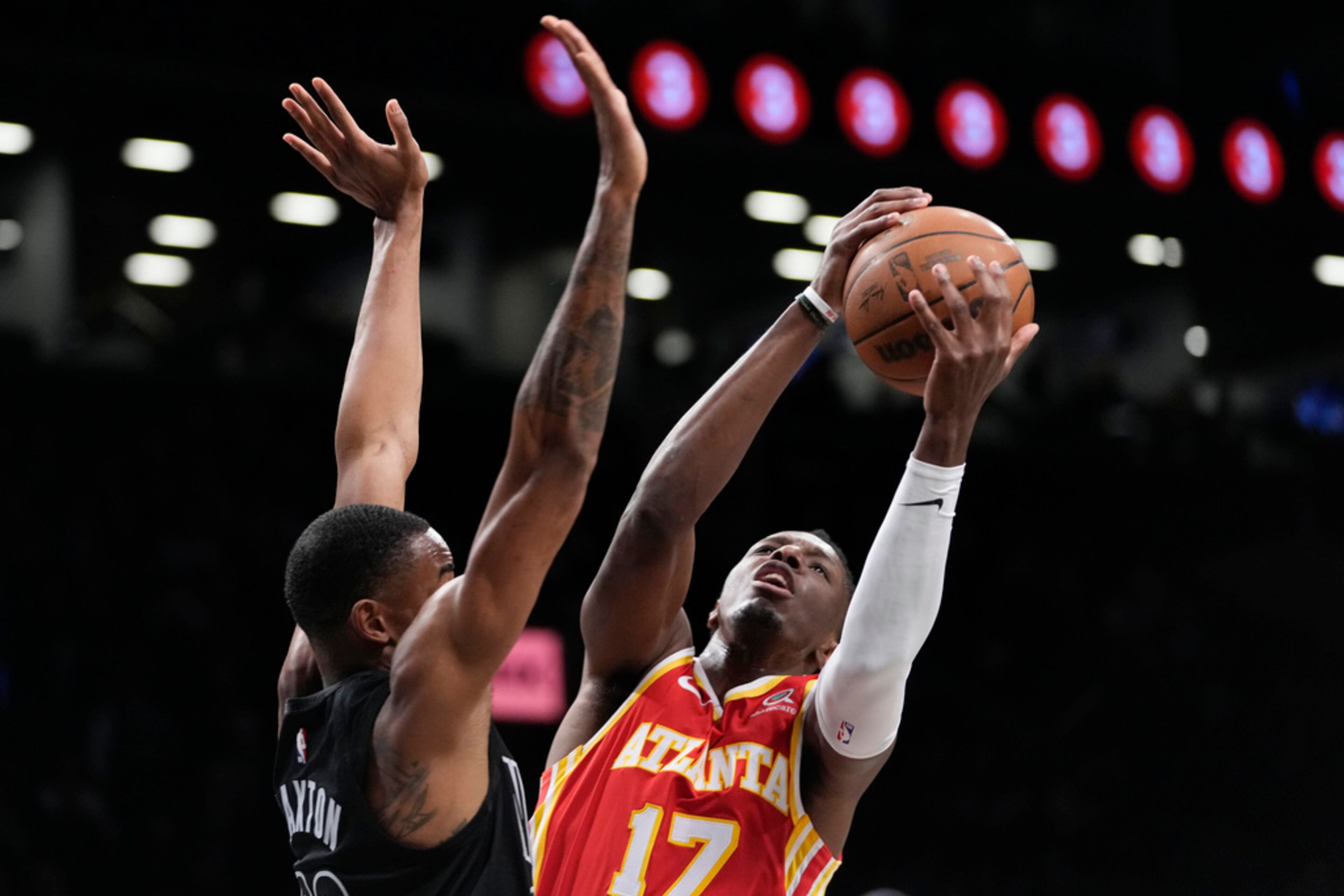 Atlanta Hawks forward Onyeka Okongwu (17) goes to the basket against Brooklyn Nets center Nic Claxton (33) during the first half of an NBA basketball game Friday, March 31, 2023, in New York. (AP Photo/Mary Altaffer)
