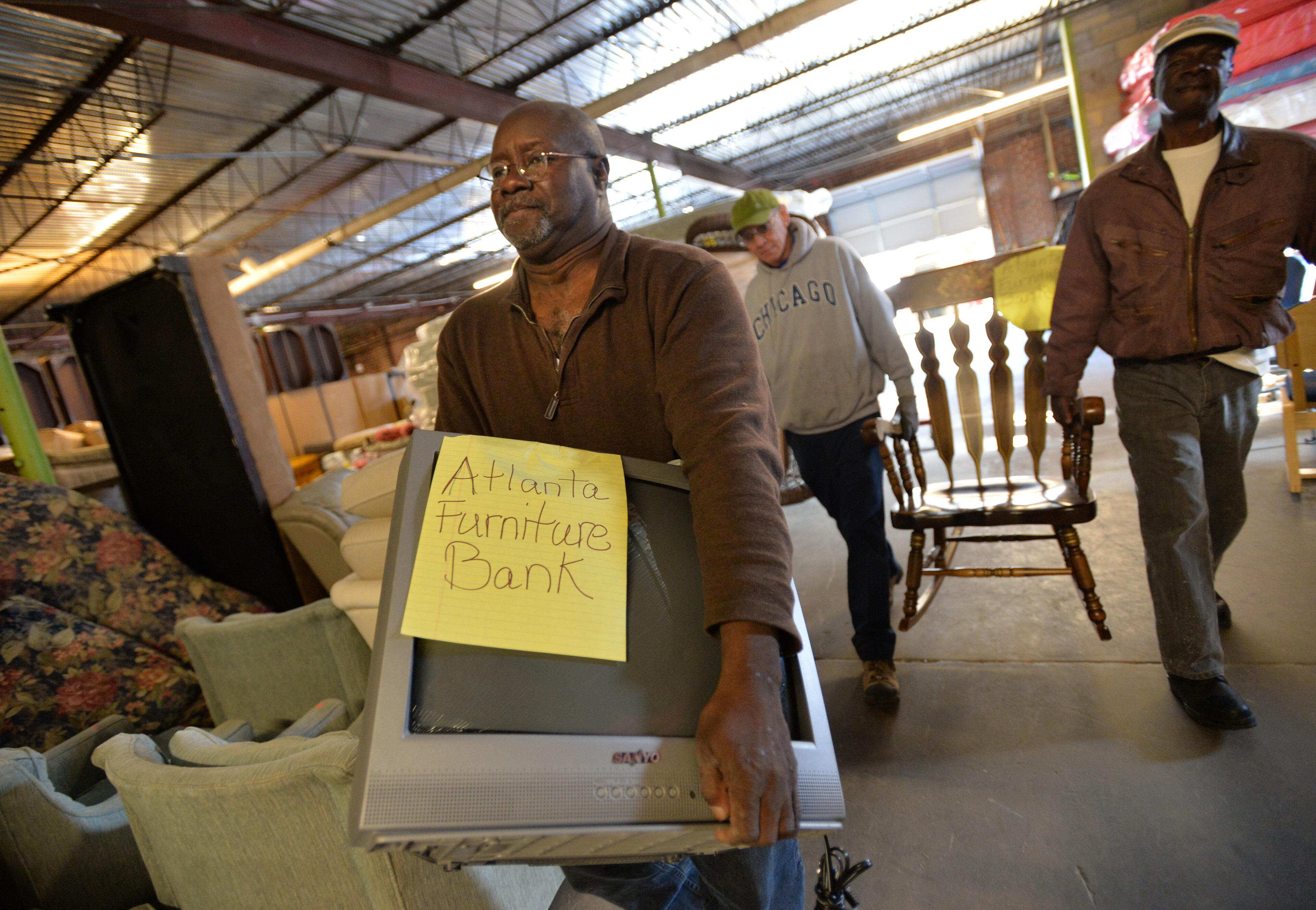 Veterans, from left, Mack Wallace, Robert Small and Ronald Sample unload donations picked up at Furniture Bank of Metro Atlanta on Thursday, November 20, 2014. Furniture Bank of Metro Atlanta has a program with the United Way where they employ homeless veterans to help them get experience in their warehouse. The program is usually a two-month internship and helps them with skills to find permanent employment. This is part of the national effort by the VA to end homelessness among veterans. HYOSUB SHIN / HSHIN@AJC.COM