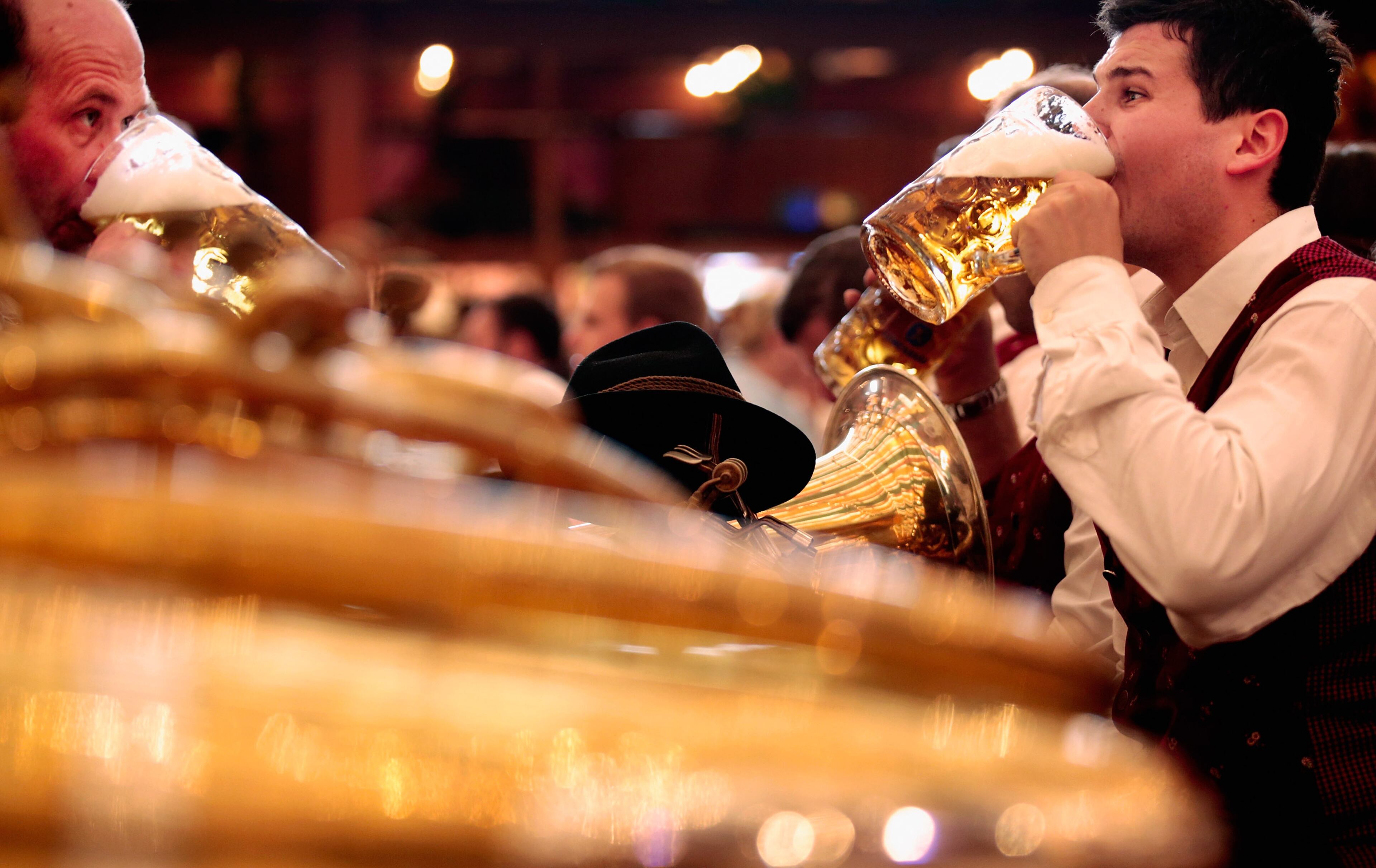 MUNICH, GERMANY - SEPTEMBER 21: Participants of the Parade of Costumes and Riflemen (Trachten- und Schuetzenzug) enjoy drinking beer at Schuetzen beer tent on the second day of the 2014 Oktoberfest on September 21, 2014 in Munich, Germany. The 181st Oktoberfest will be open to the public from September 20 through October 5 and traditionally draws millions of visitors from across the globe in the world's largest beer fest. (Photo by Johannes Simon/Getty Images)