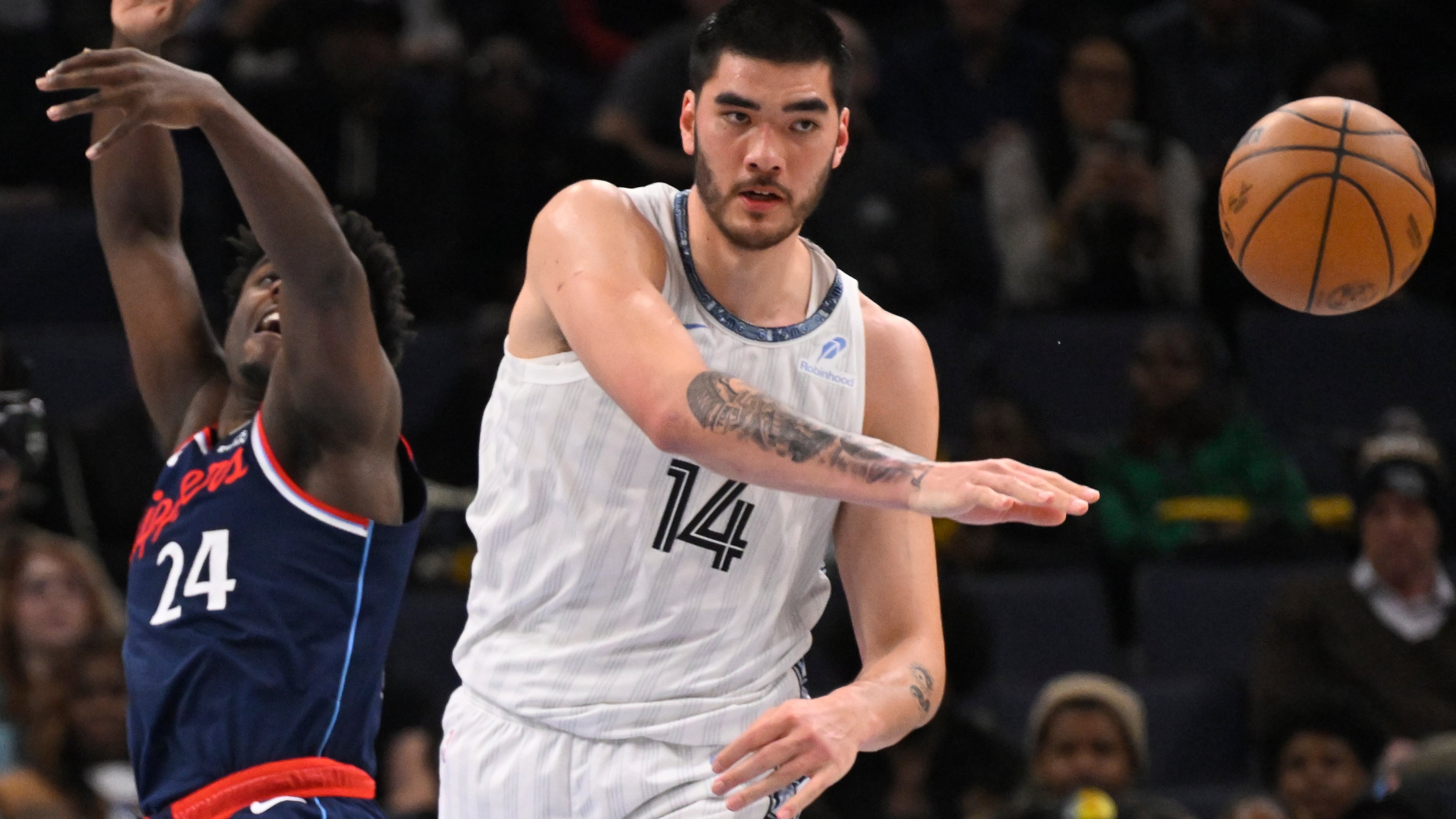 FILE - Memphis Grizzlies center Zach Edey (14) passes away from Los Angeles Clippers forward Kobe Brown (24) during an NBA basketball game Friday, Dec. 5, 2025, in Memphis, Tenn. (AP Photo/John Amis, file)