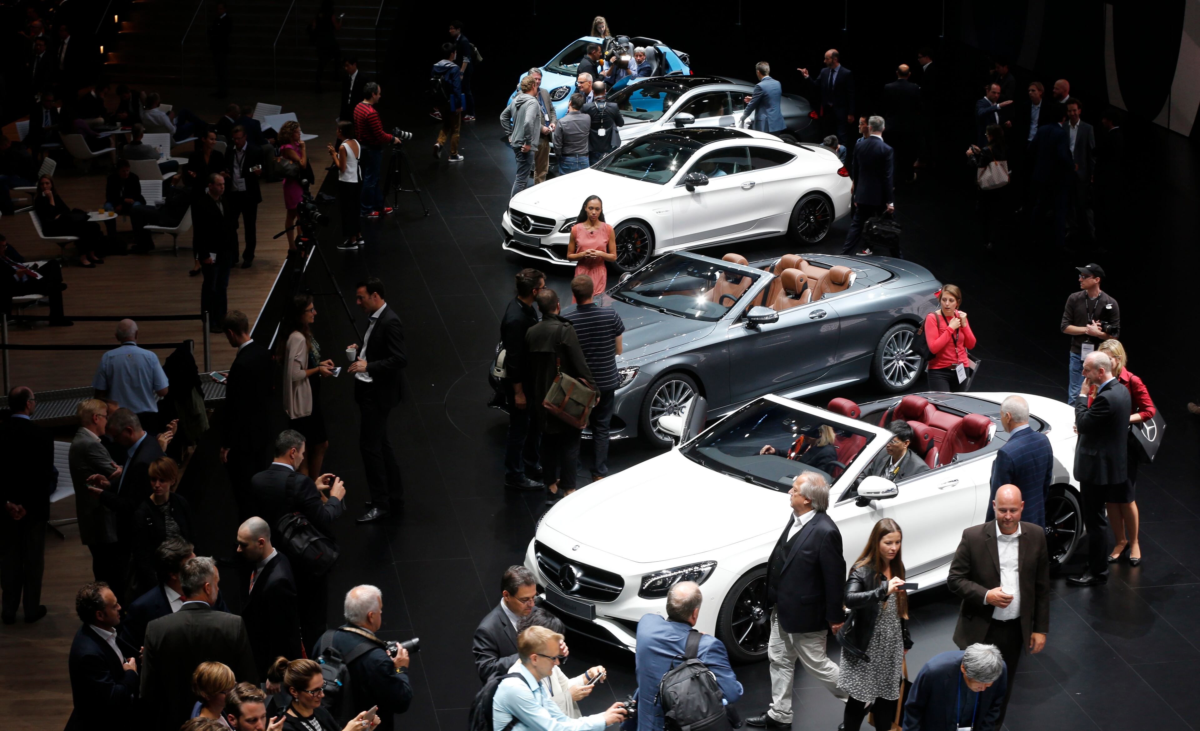 Visitors surround cars in the Mercedes hall on the first press day of the Frankfurt Auto Show IAA in Frankfurt, Germany, Tuesday, Sept. 15, 2015. The car show runs through Sept. 27. (AP Photo/Michael Probst)
