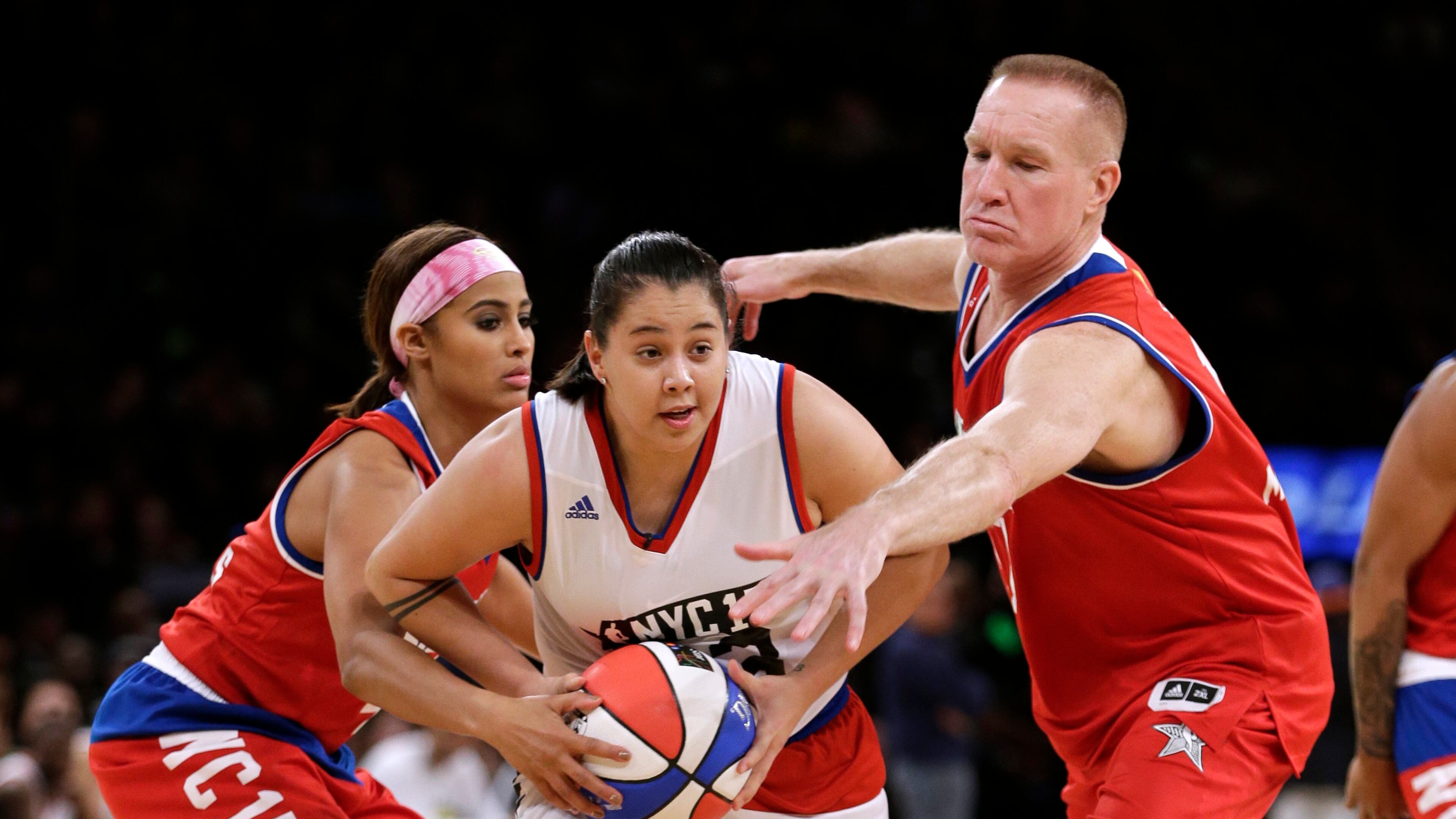 Skylar Diggins, left, and Chris Mullin, right, defend Shoni Schimmel, center, during the second half of the NBA All-Star celebrity basketball game Friday, Feb. 13, 2015, in New York. (AP Photo/Frank Franklin II)