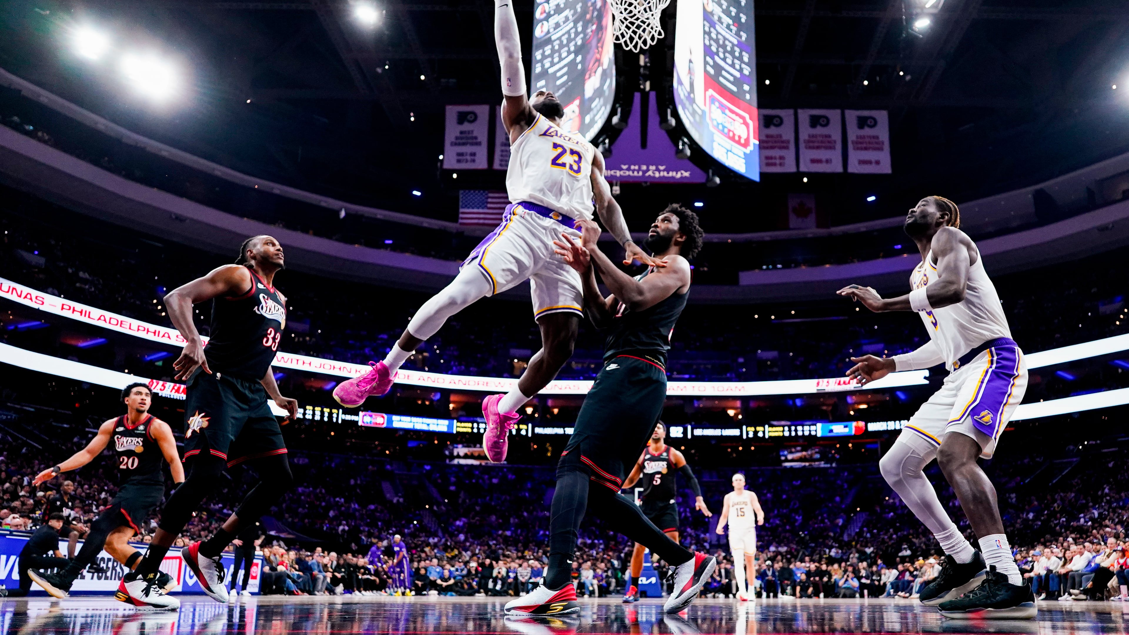 FILE - Los Angeles Lakers' LeBron James, center left, goes up for the shot against Philadelphia 76ers' Joel Embiid, center right, during the second half of an NBA basketball game, Dec. 7, 2025, in Philadelphia. (AP Photo/Chris Szagola, File)