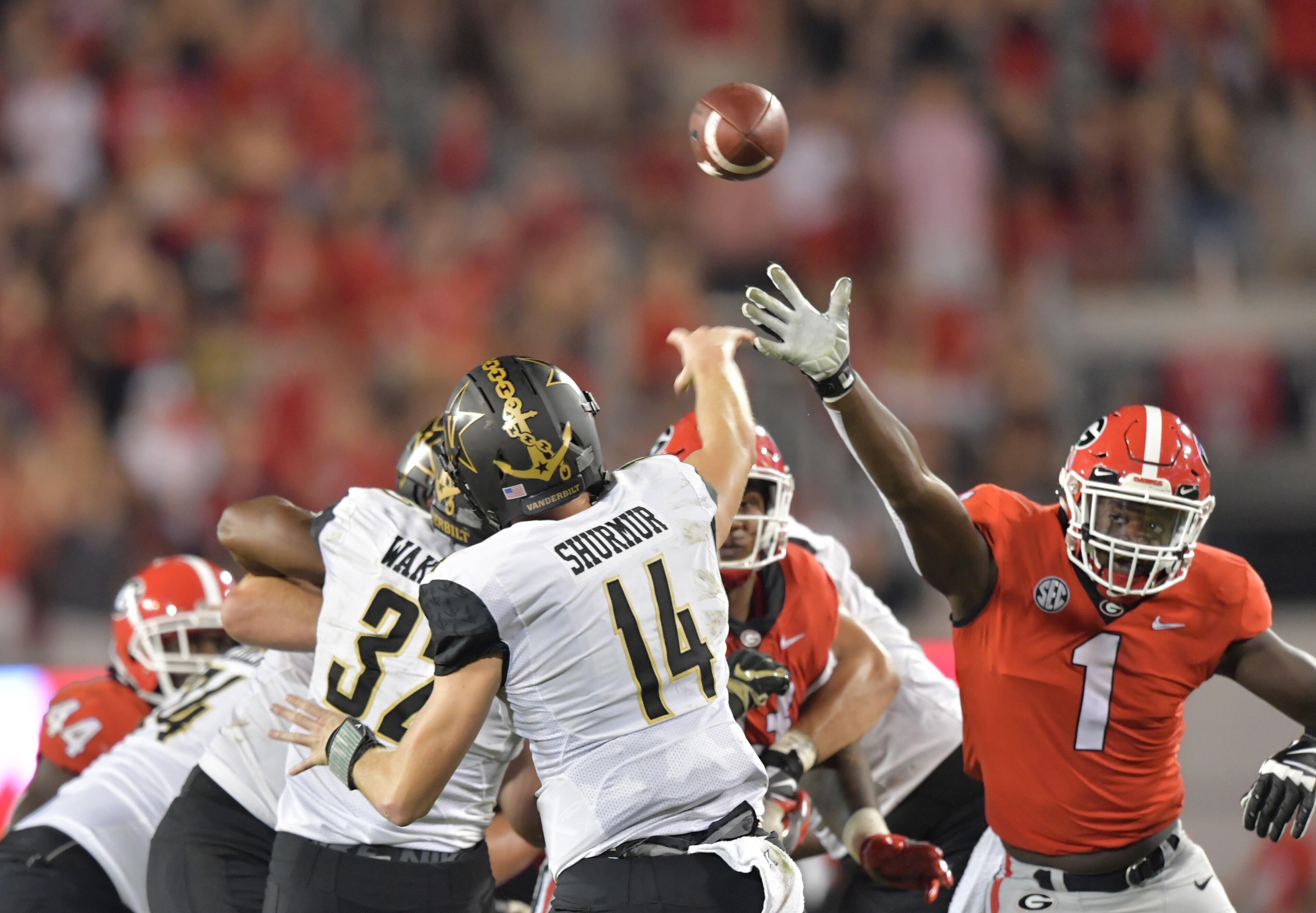 October 6, 2018 Athens - Vanderbilt quarterback Kyle Shurmur (14) gets off a pass as Georgia linebacker Brenton Cox (1) tries to block in the second half during a NCAA college football game at Sanford Stadium in Athens on Saturday, October 6, 2018. Georgia won 41-13 over the Vanderbilt. HYOSUB SHIN / HSHIN@AJC.COM