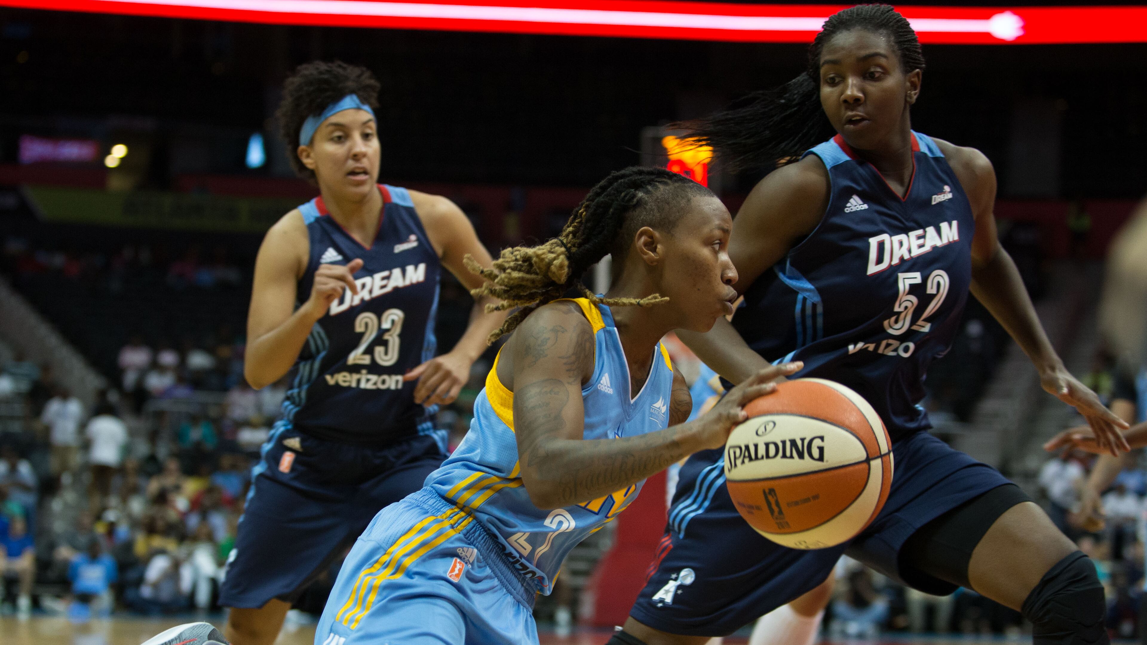 Chicago Sky guard Jamierra Faulkner (21) , center, drives to the basket while being defended by Atlanta Dream’s Elizabeth Williams (52), right, and Atlanta Dream guard Layshia Clarendon (23) during a game between the Atlanta Dream and Chicago Sky at Phillips Arena, Sunday, May 22, 2016, in Atlanta. The Atlanta Dream defeated Chicago Sky 87-81.
