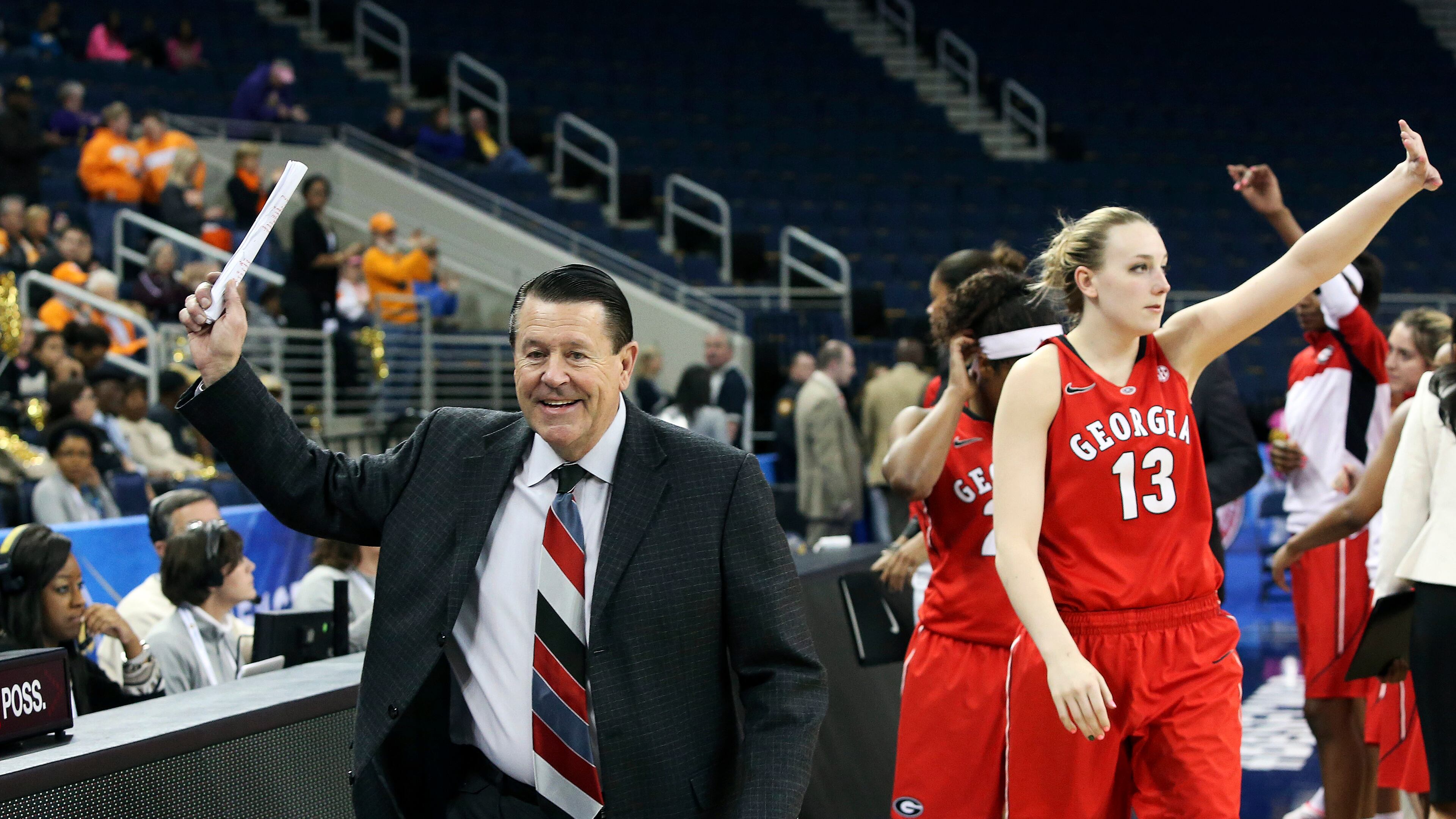 Georgia head coach Andy Landers, left, waves to the crowd as he leaves the court after defeating Vanderbilt 53-43 in a second-round women's Southeastern Conference tournament NCAA college basketball game Thursday, March 6, 2014, in Duluth, Ga. Georgia forward Merritt Hempe (13) waves in the background.
