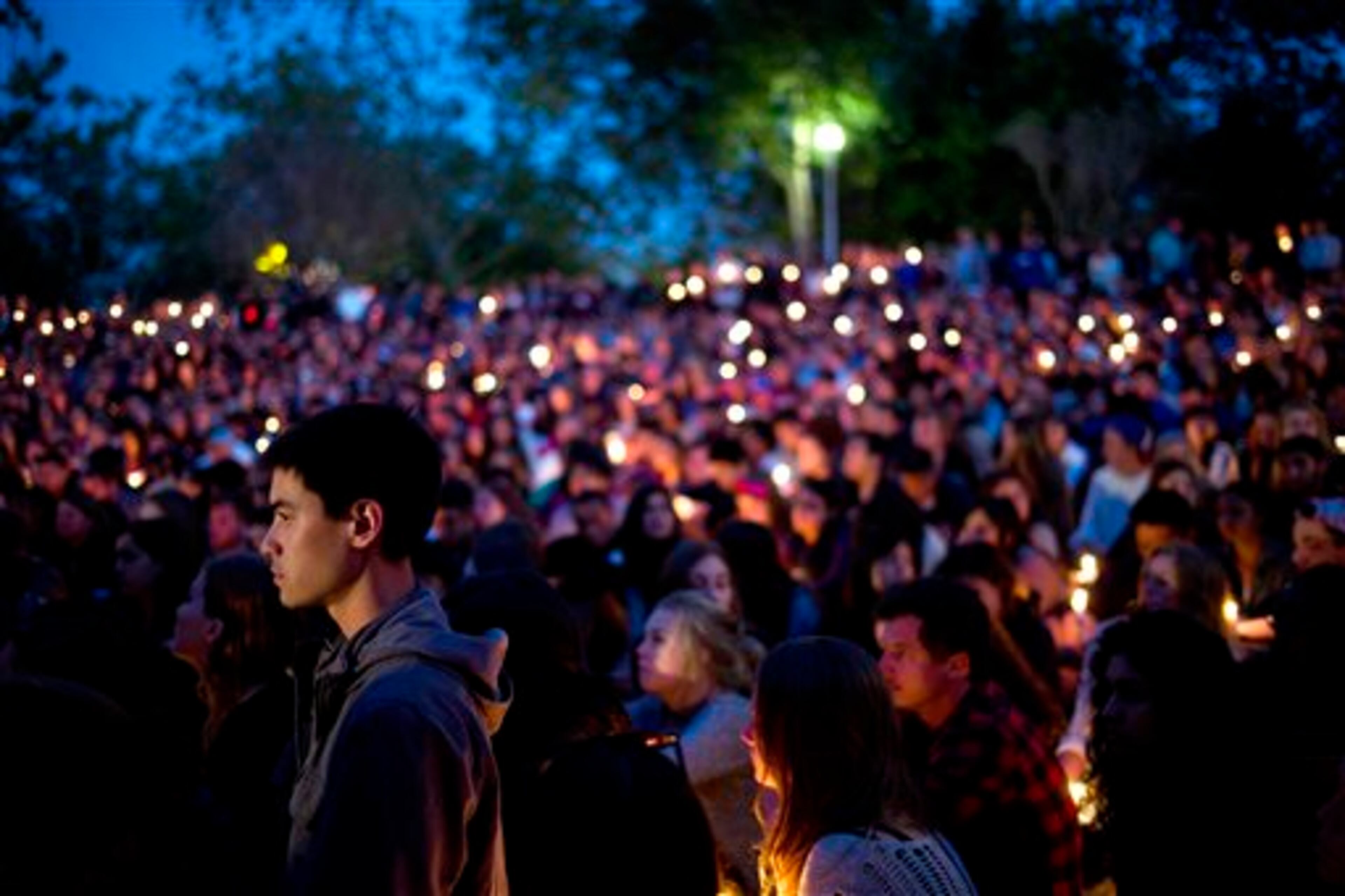 People gather at a park for a candlelight vigil to honor the victims of Friday night's mass shooting on Saturday, May 24, 2014, in Isla Vista, Calif. Sheriff's officials say Elliot Rodger, 22, went on a rampage near the University of California, Santa Barbara, stabbing three people to death at his apartment before shooting and killing three more in a crime spree through a nearby neighborhood. (AP Photo/Jae C. Hong)