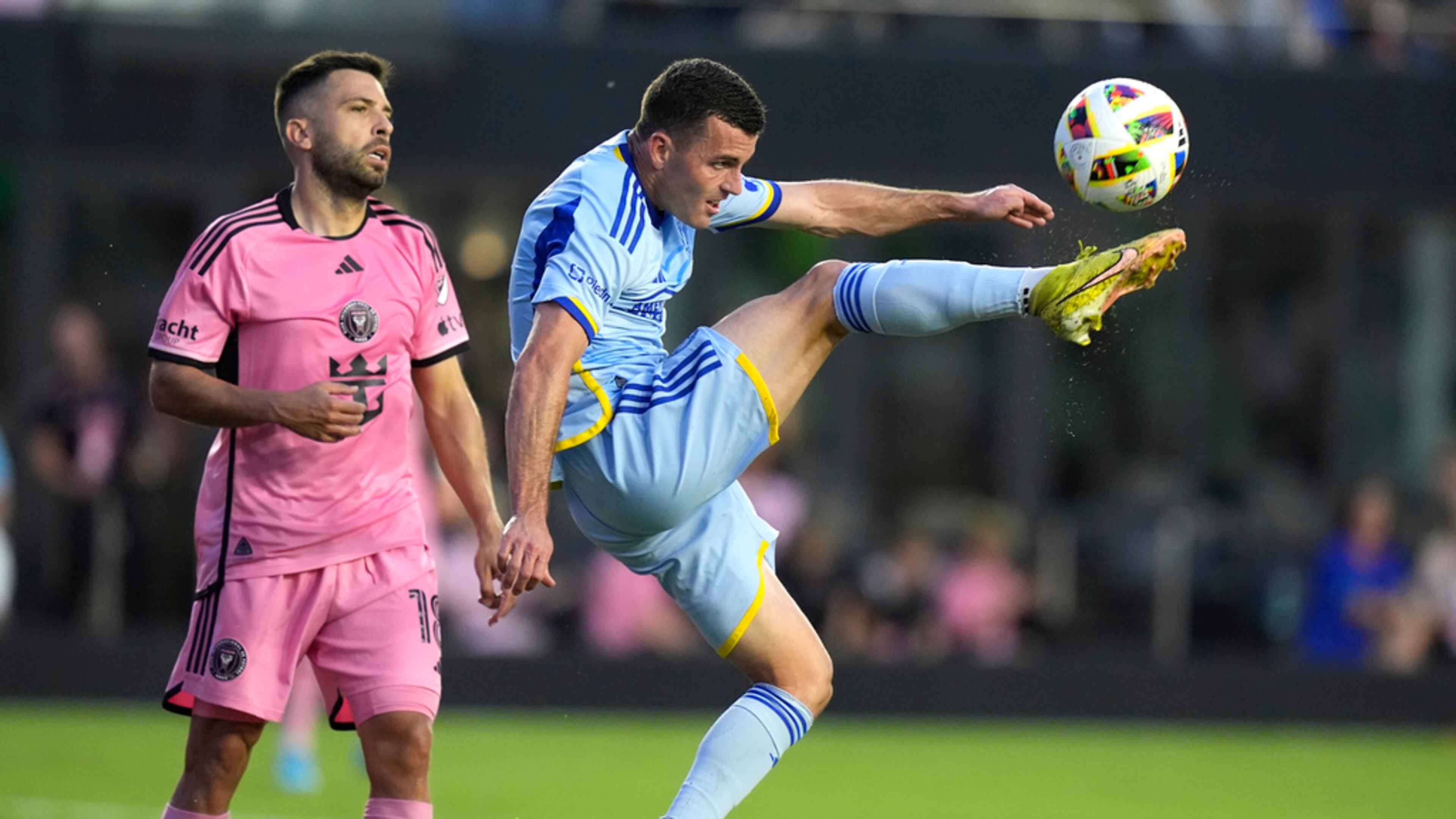 Atlanta United defender Brooks Lennon, right, kicks the ball during the first half of the team's MLS soccer match against Inter Miami on Wednesday, May 29, 2024, in Fort Lauderdale, Fla. At left is Inter Miami defender Jordi Alba (18). (AP Photo/Lynne Sladky)