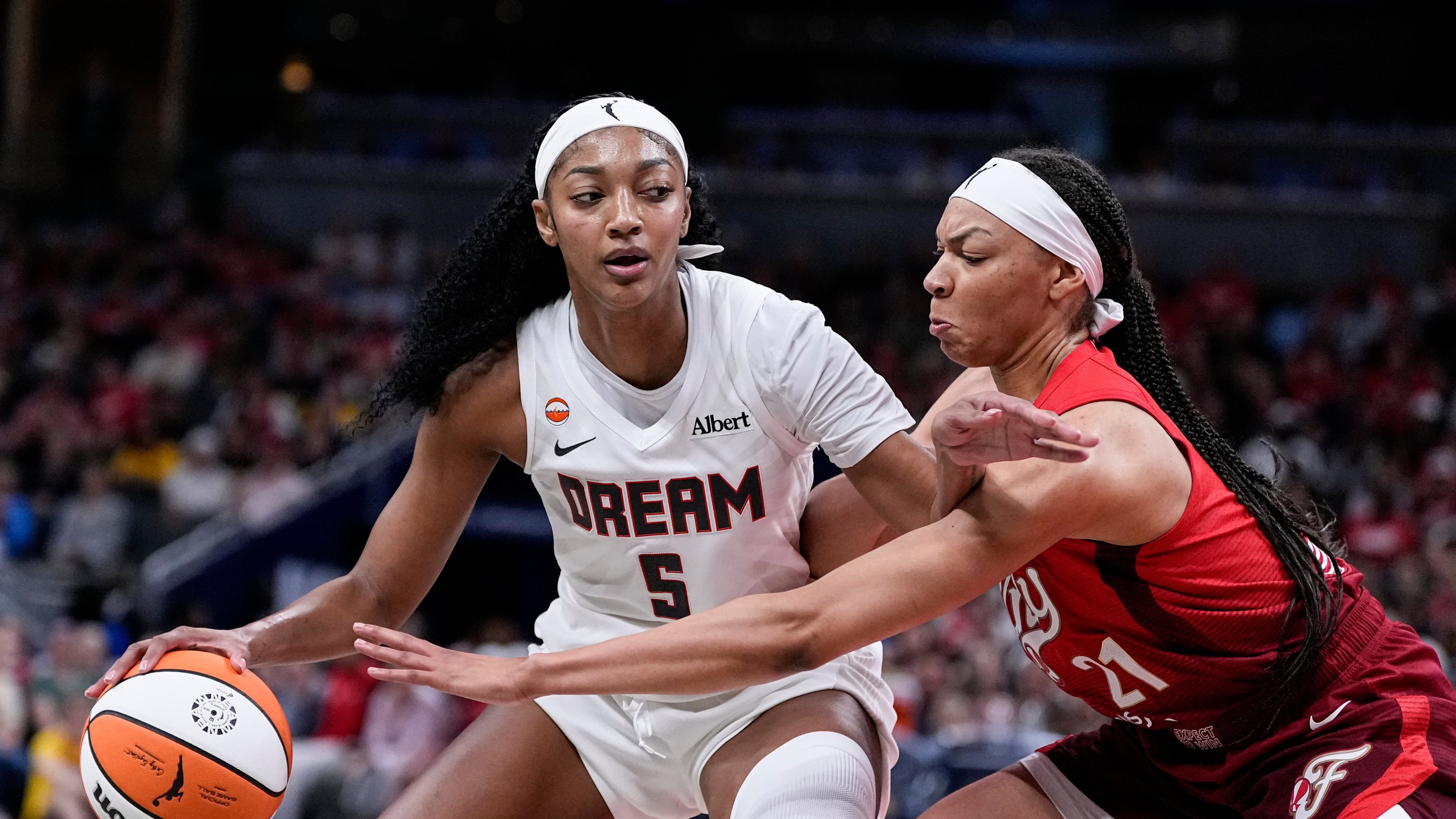 Indiana Fever forward Makayla Timpson (21) defends Atlanta Dream forward Angel Reese (5) in the second half of a WNBA basketball game in Indianapolis, Thursday, June 18, 2026. (AP Photo/Michael Conroy)