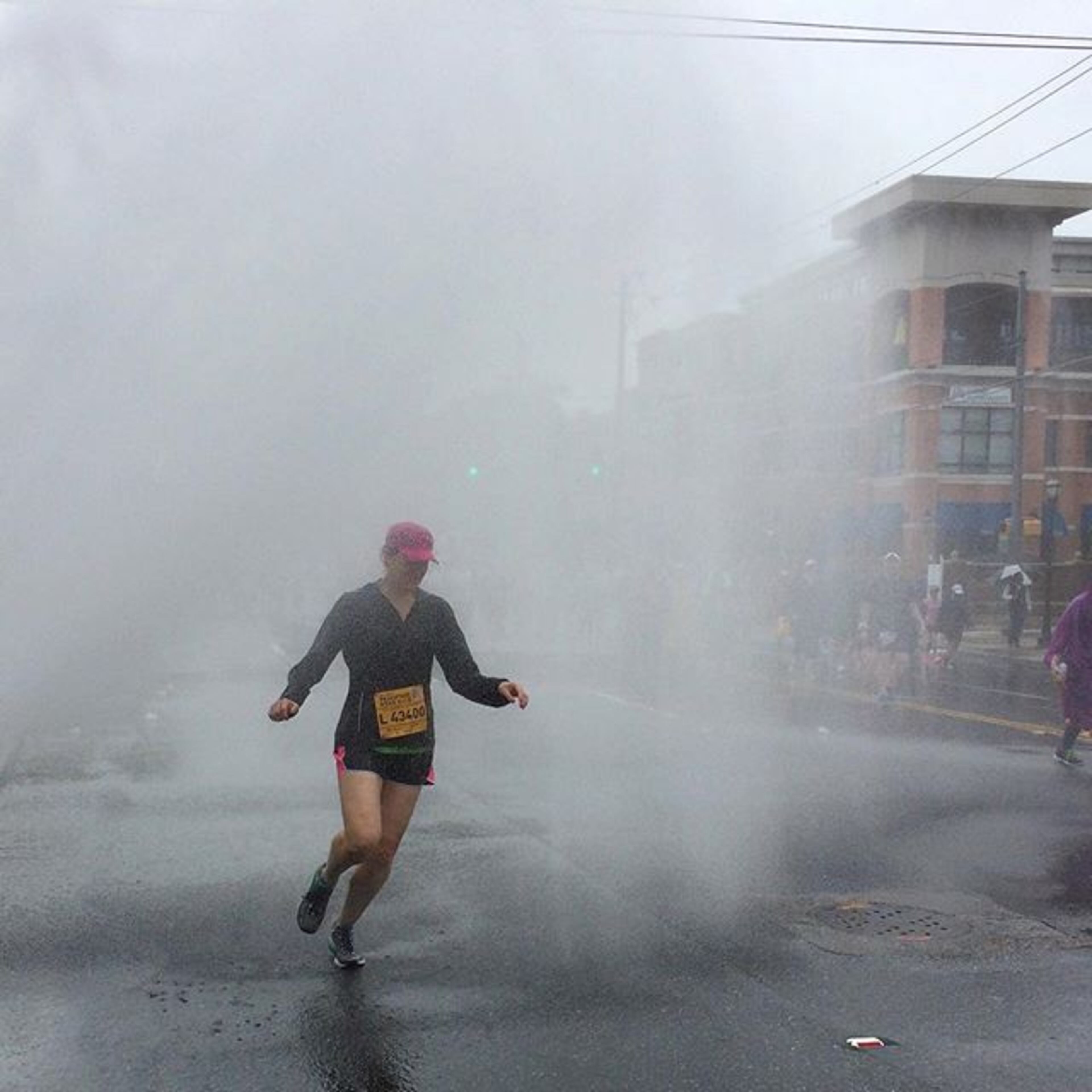 @photobgray: #runography A runner makes her way through an unnecessary water spray during the 2015 AJC Peachtree Road Race. See full coverage on AJC.com and in the Sunday AJC. #ajcprr