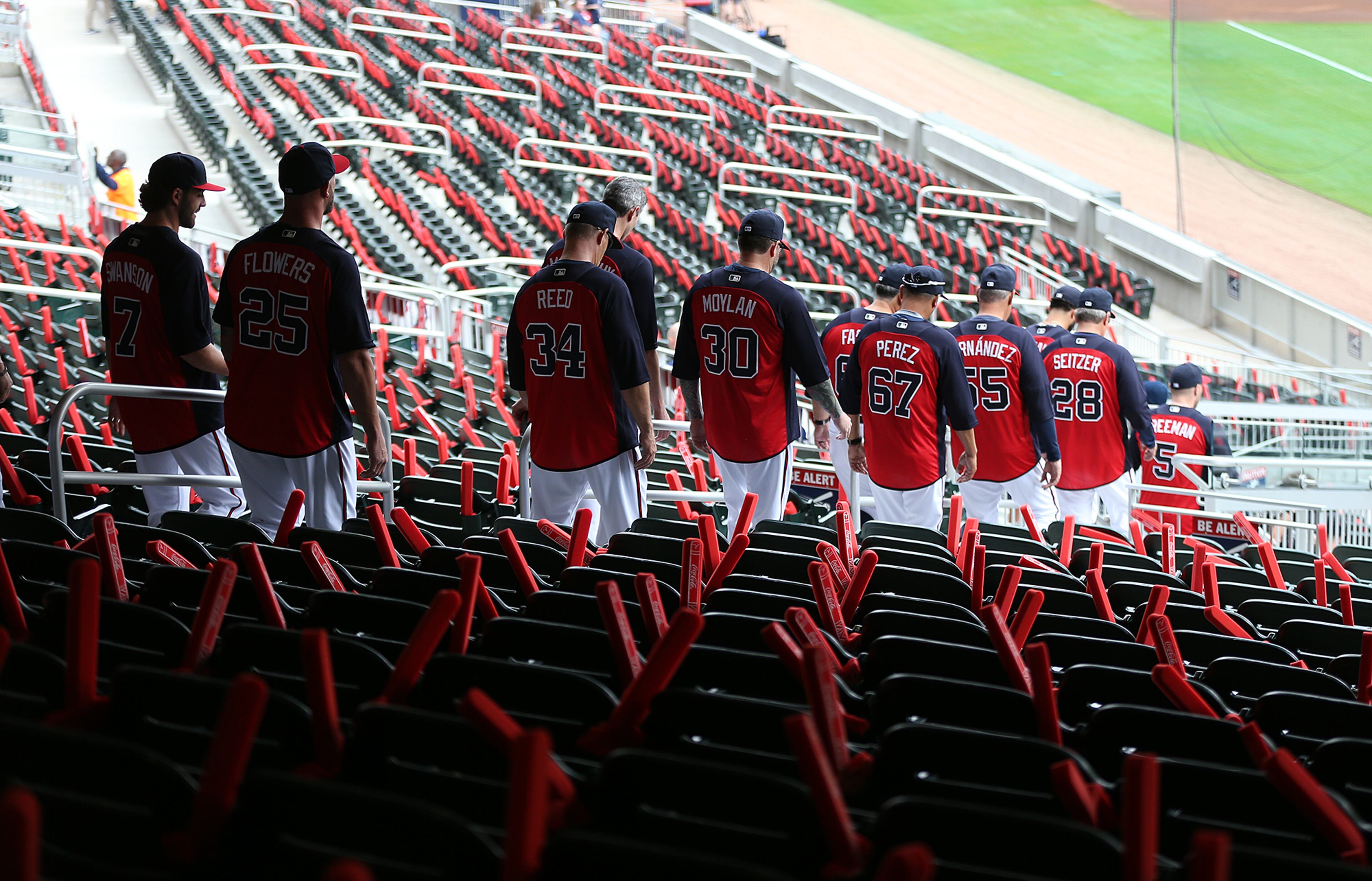The Braves enter SunTrust Park for batting practice at the end of the Brave Walk parade. (Curtis Compton/ccompton@ajc.com)