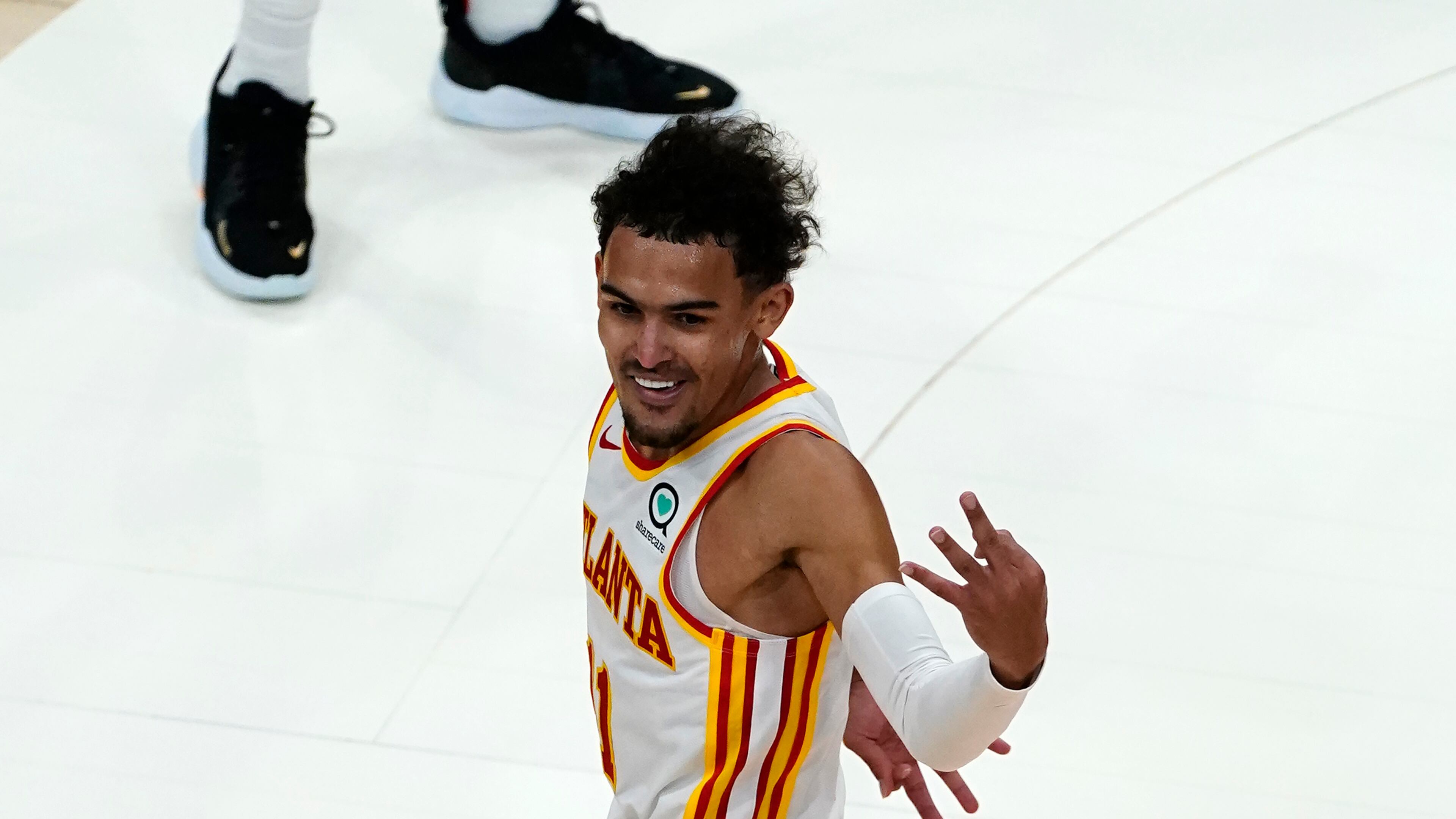 Atlanta Hawks guard Trae Young (11) reacts after an Atlanta basket in the second half of an NBA basketball game against the New Orleans Pelicans Tuesday, April 6, 2021, in Atlanta. (AP Photo/John Bazemore)