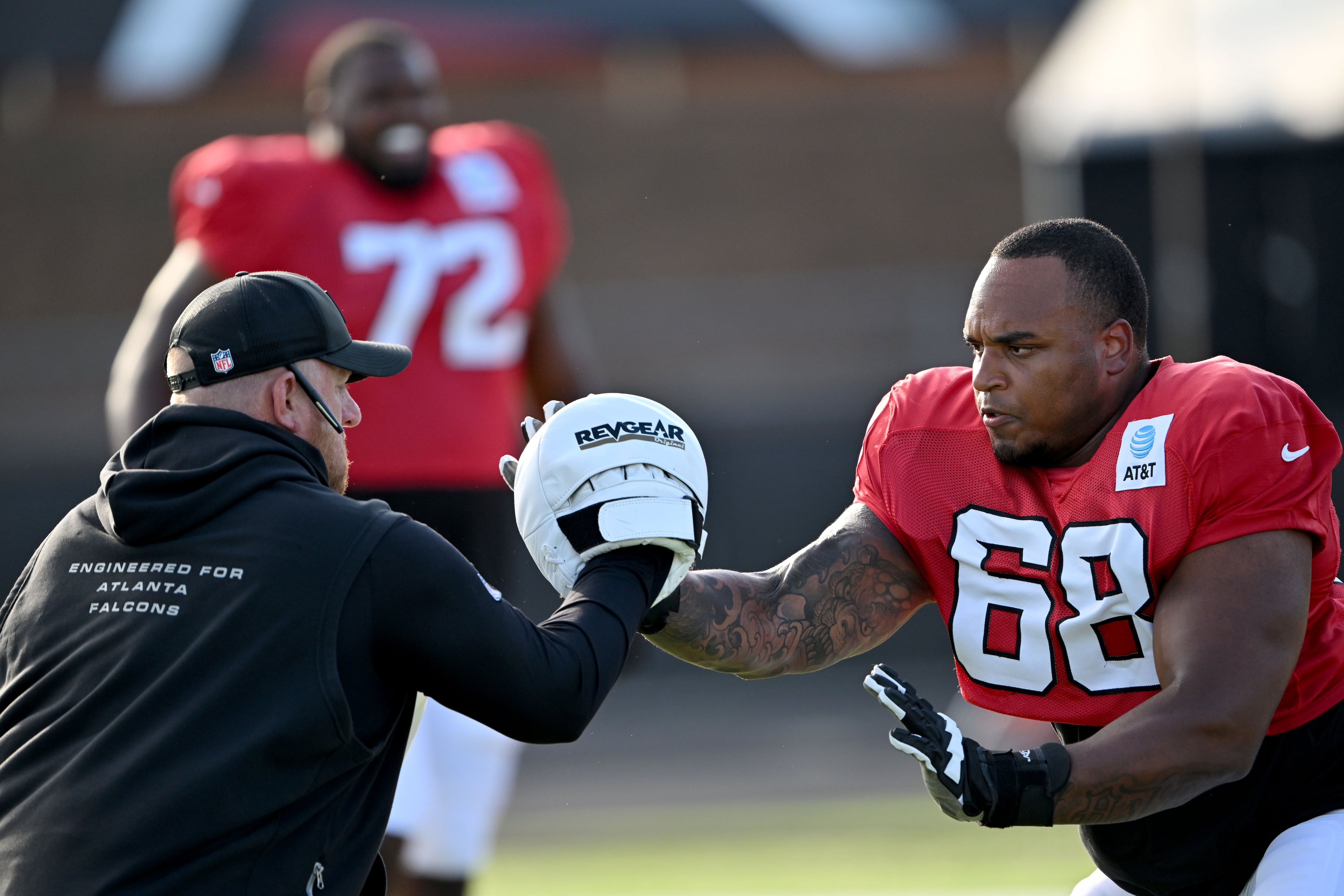 The Falcons' Kyle Hinton (right) runs a drill during "Saturday Night Lights" practice Saturday, Aug. 8, 2026, at Lanier High School in Sugar Hill. (Hyosub Shin/AJC)
