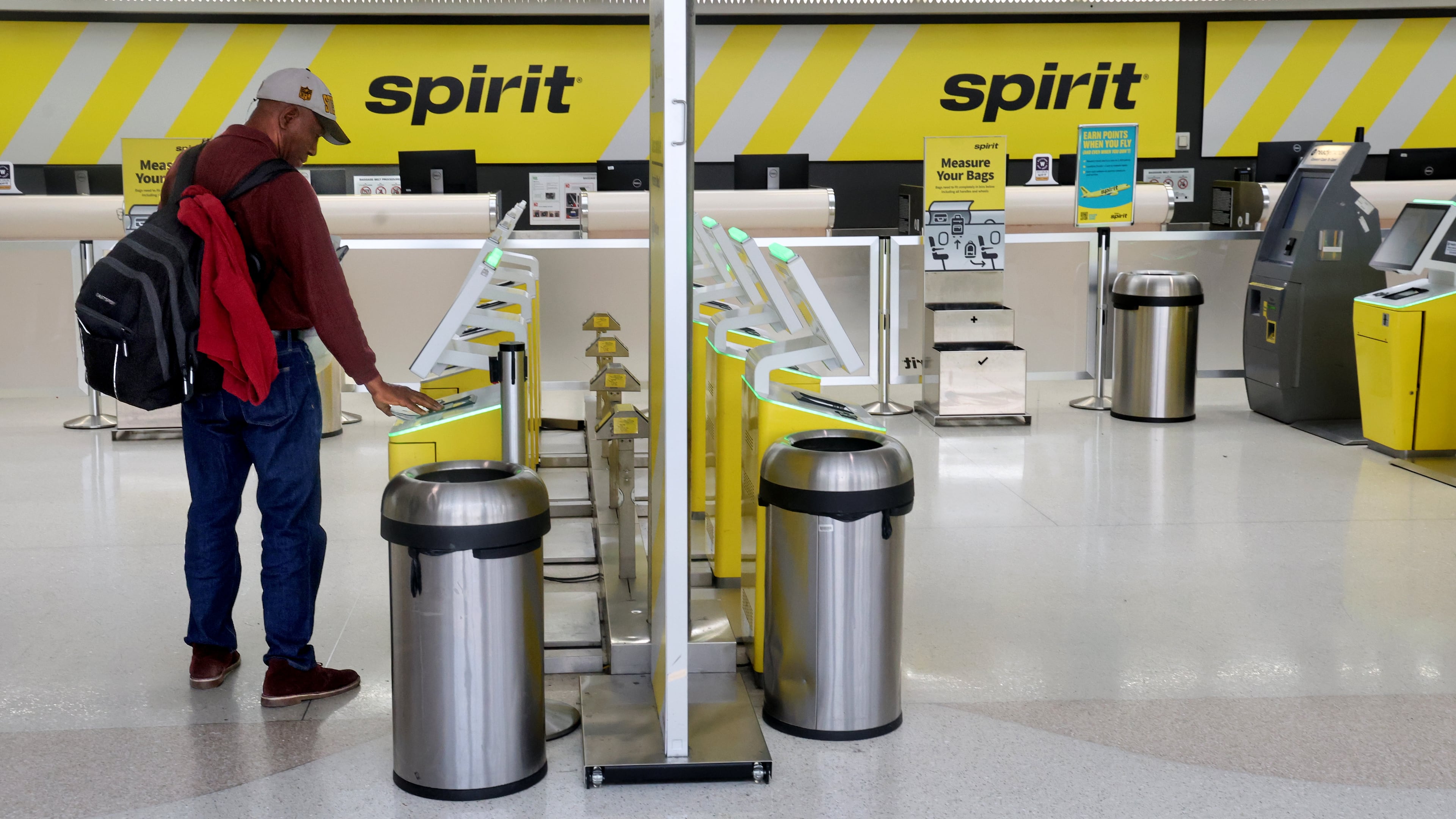 Pierre Ronet tries to check in to his flight to Tampa on Spirit Airlines at Fort Lauderdale-Hollywood International Airport, only to find out it was cancelled on Saturday, May 2, 2026. (Mike Stocker /South Florida Sun-Sentinel via AP)