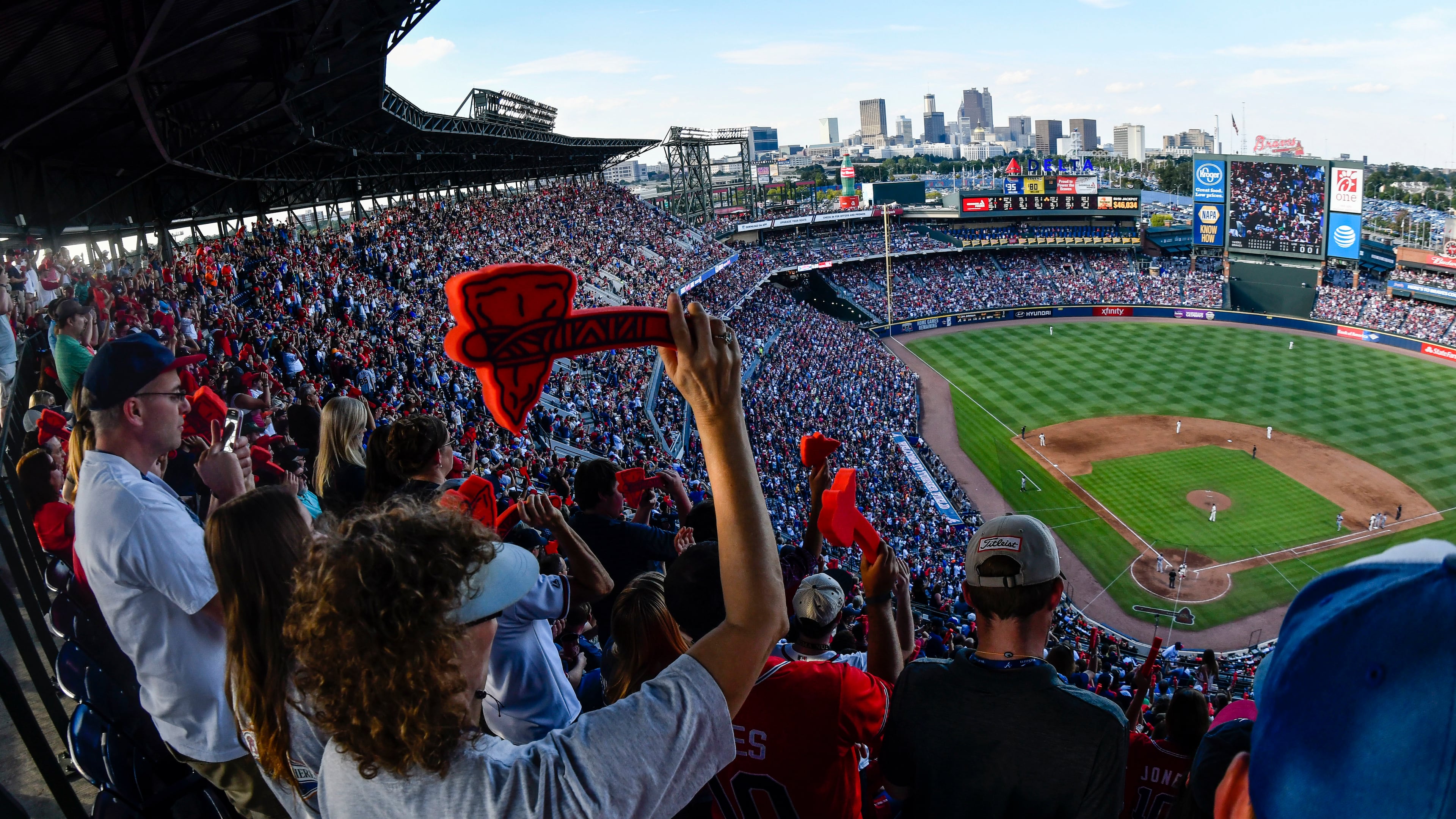 Atlanta Braves fans cheer with a tomahawk chop during the ninth inning of a baseball game against the Detroit Tigers, and the Braves' final game at Turner Field, Sunday, Oct. 2, 2016, in Atlanta. The franchise is planning on starting next season at SunTrust Park which is under construction in Cobb County. (AP Photo/John Amis)