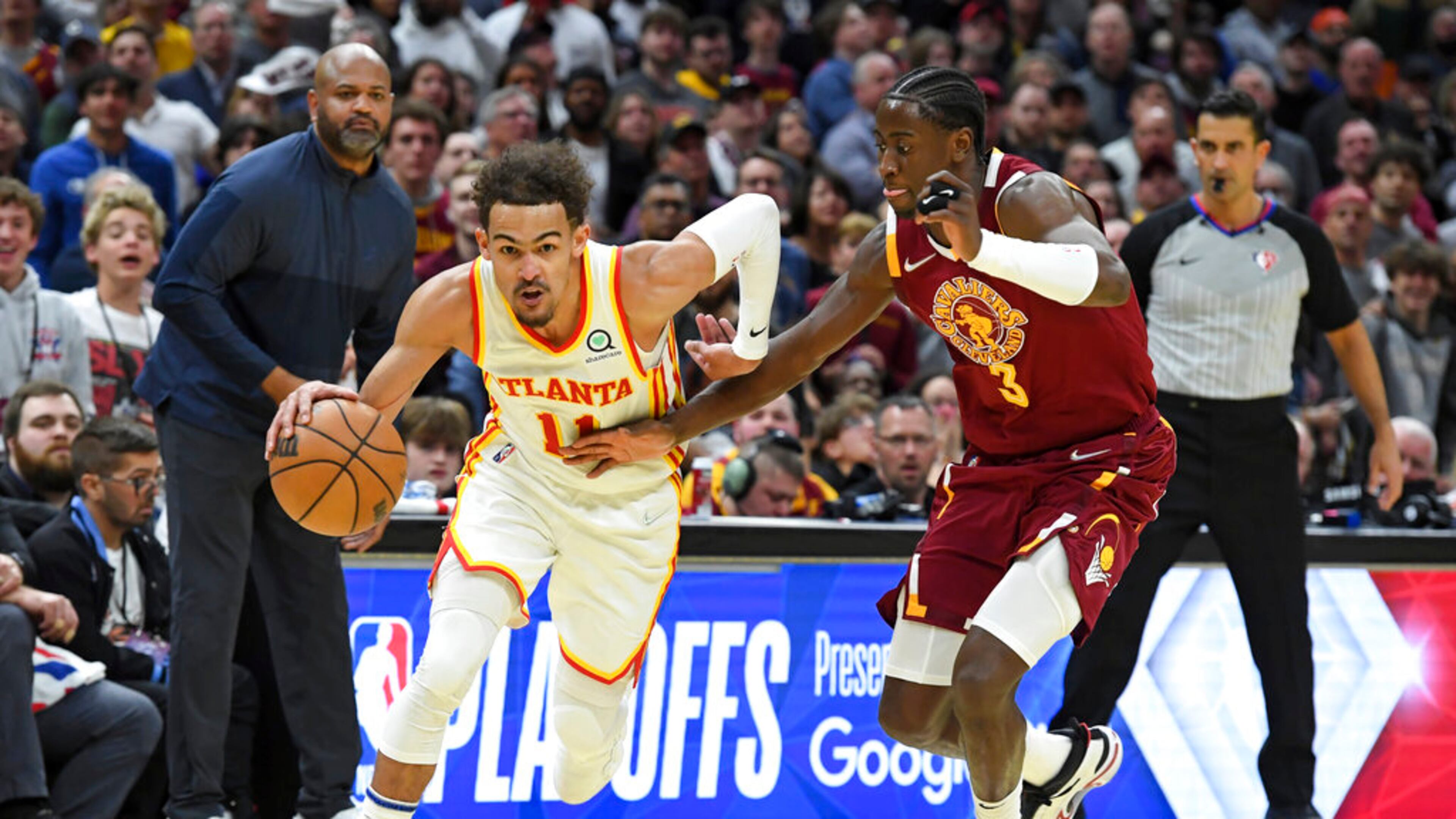 Atlanta Hawks' Trae Young (11) drives against Cleveland Cavaliers' Caris LeVert (3) in the second half of an NBA play-in basketball game Friday, April 15, 2022, in Cleveland. (AP Photo/Nick Cammett)